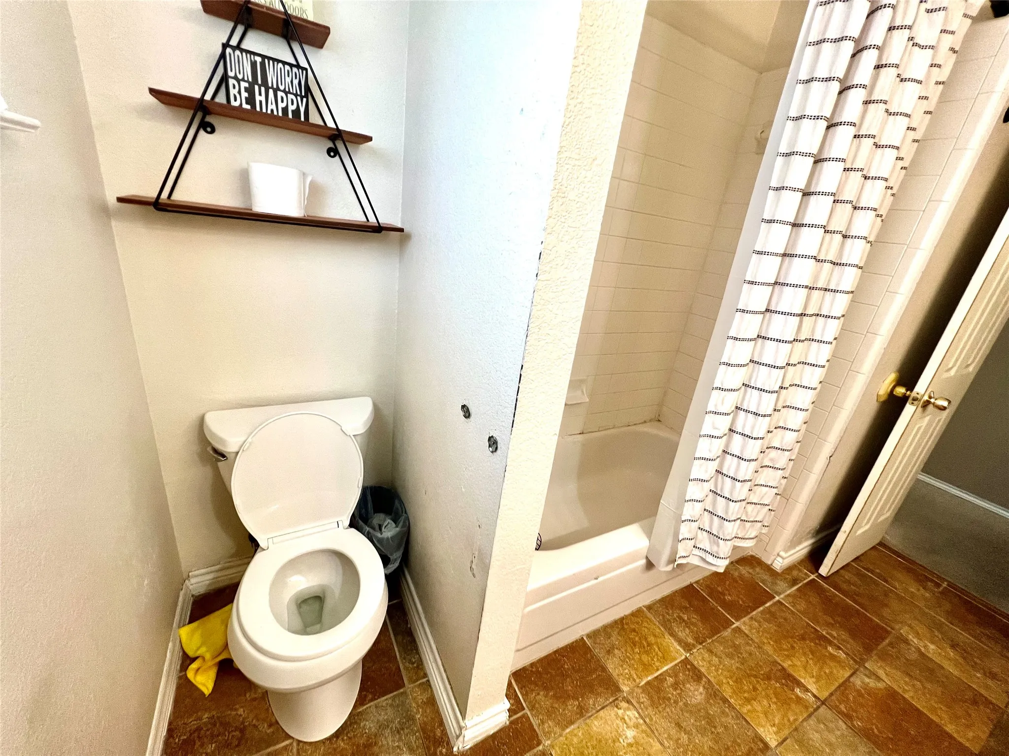Full bath featuring stone finish flooring and shower / bath combination with curtain