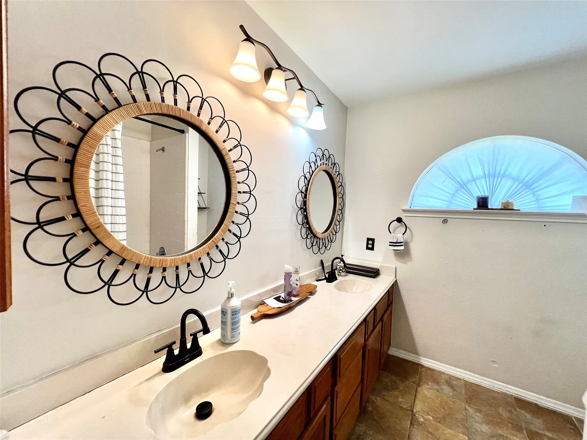 Full bathroom featuring double vanity and stone finish floors