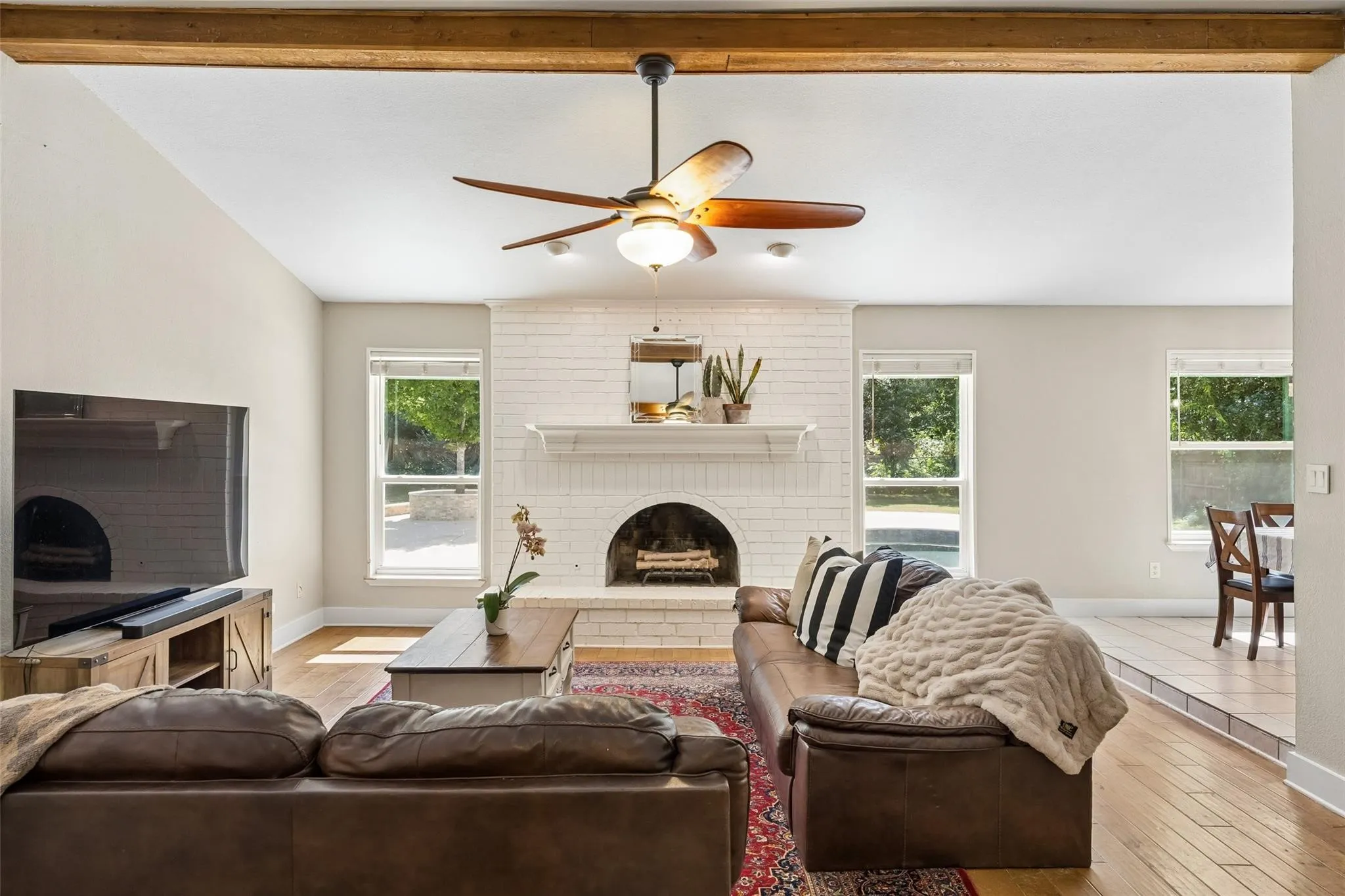 Living space featuring vaulted ceilings and exposed wood beams