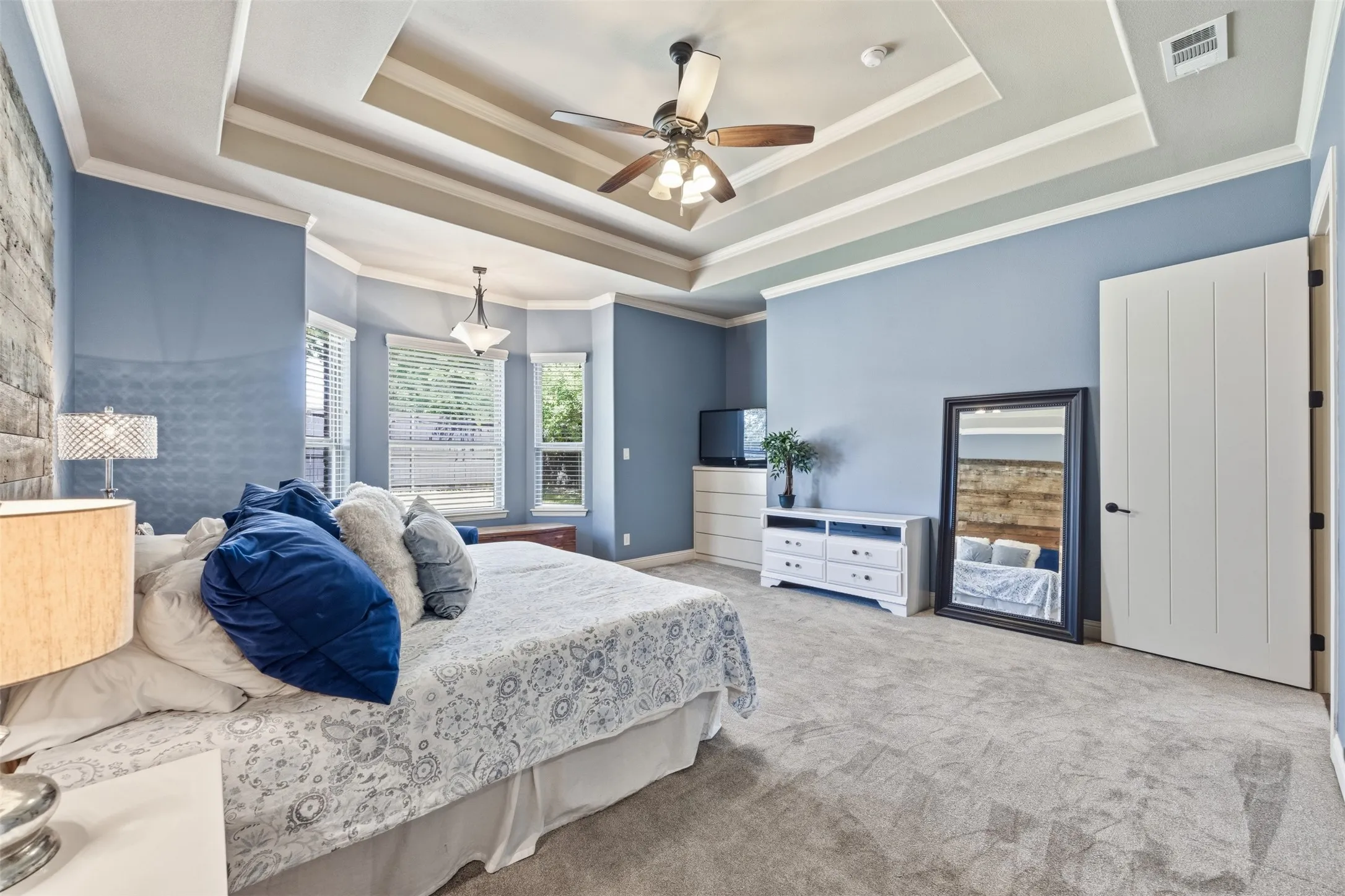 Primary bedroom with additional sitting area and custom accents