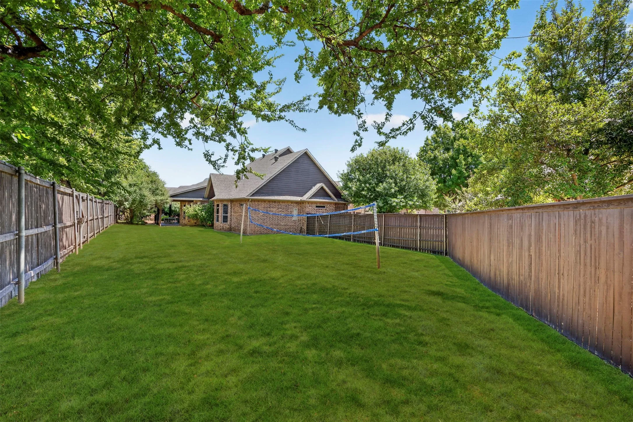 Oversized side yard with grass volleyball court