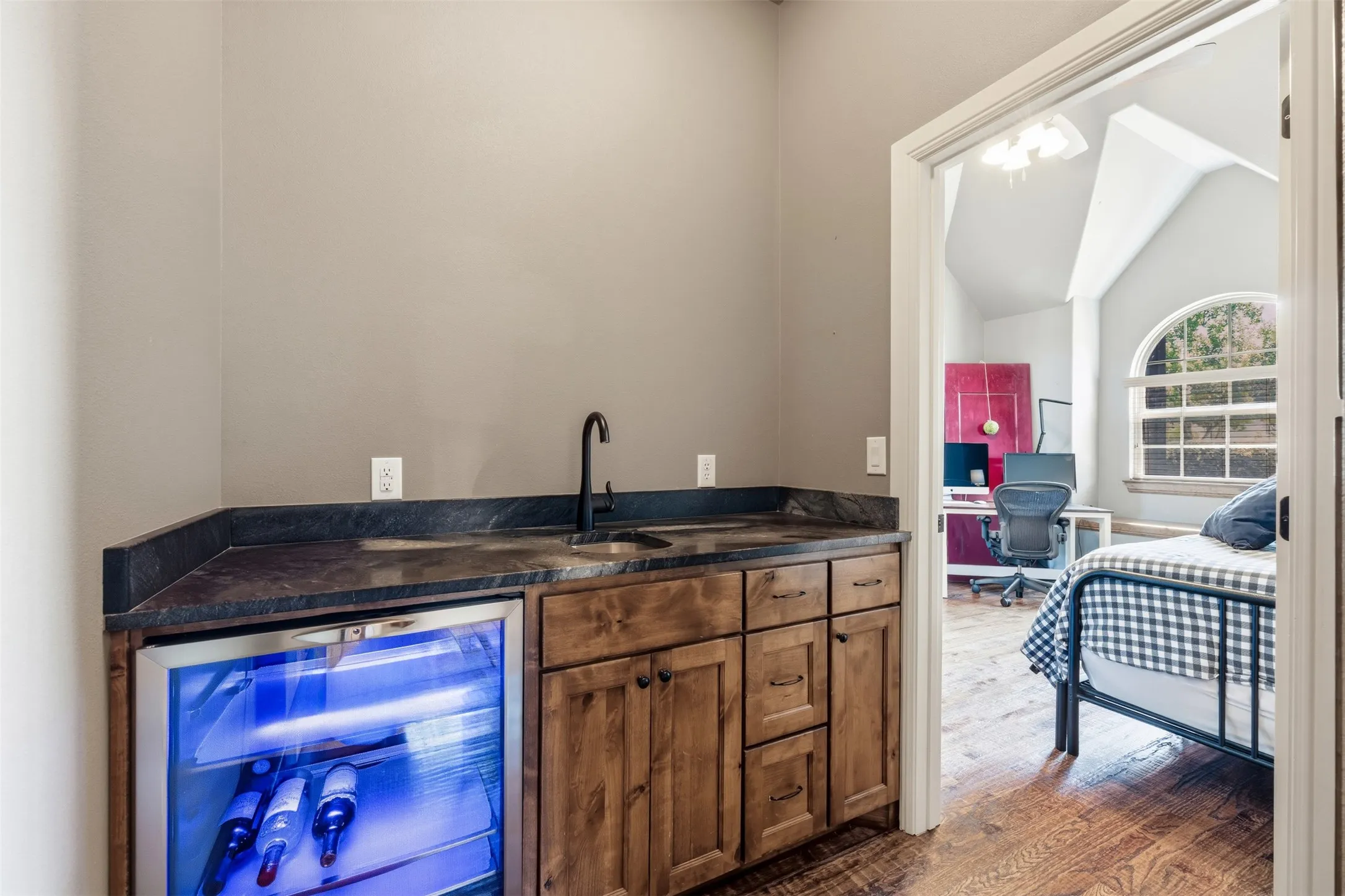 Wet bar conveniently located between primary bedroom and office