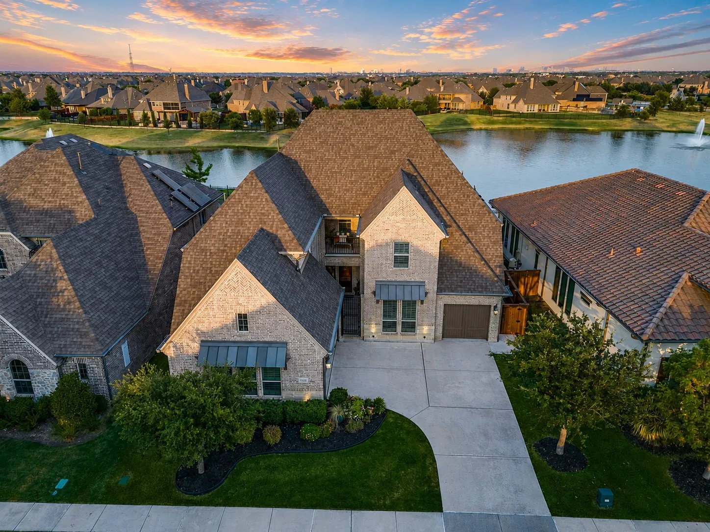 The elevated view showcases this home’s impressive architecture and incredible waterfront setting, with peaceful pond views just beyond the backyard. A truly special property offering luxury living surrounded by water views and spectacular Texas sunsets.
