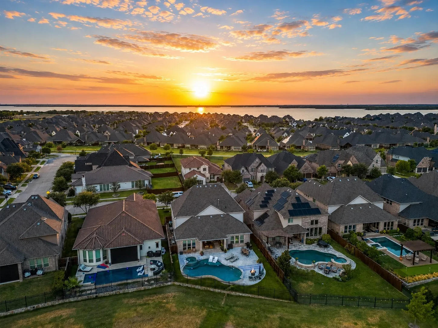 Experience luxury living in your own private retreat, surrounded by beautiful water views and unforgettable Texas sunsets. This exceptional setting combines resort-style outdoor living with the serenity of a lakeside community, all just a few steps away from the shorelines of Lake Lewisville. A truly remarkable place to call home.
