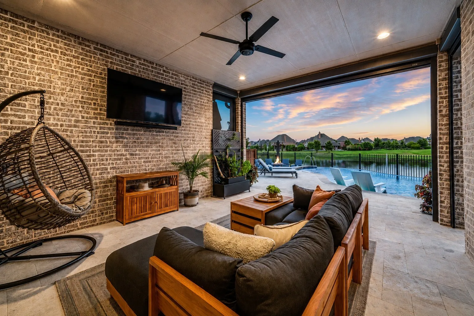 Step into your own private backyard oasis from this expansive covered patio, designed for effortless indoor-outdoor living. Automatic screens and built-in surround sound create the perfect setting for relaxing or entertaining year-round, while the open-air design frames breathtaking water views. With the pool just steps away, this incredible outdoor living space is made for enjoying the best of resort-style living at home.