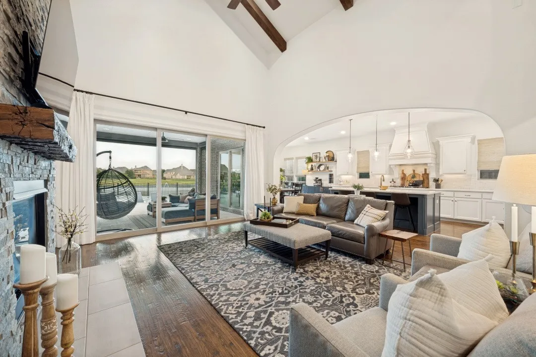 This beautifully designed living area flows effortlessly into the open kitchen, creating a spacious and inviting setting for everyday living and entertaining. Expansive sliding glass doors frame gorgeous water views and open directly to your backyard paradise, seamlessly blending indoor and outdoor living while filling the space with natural light.