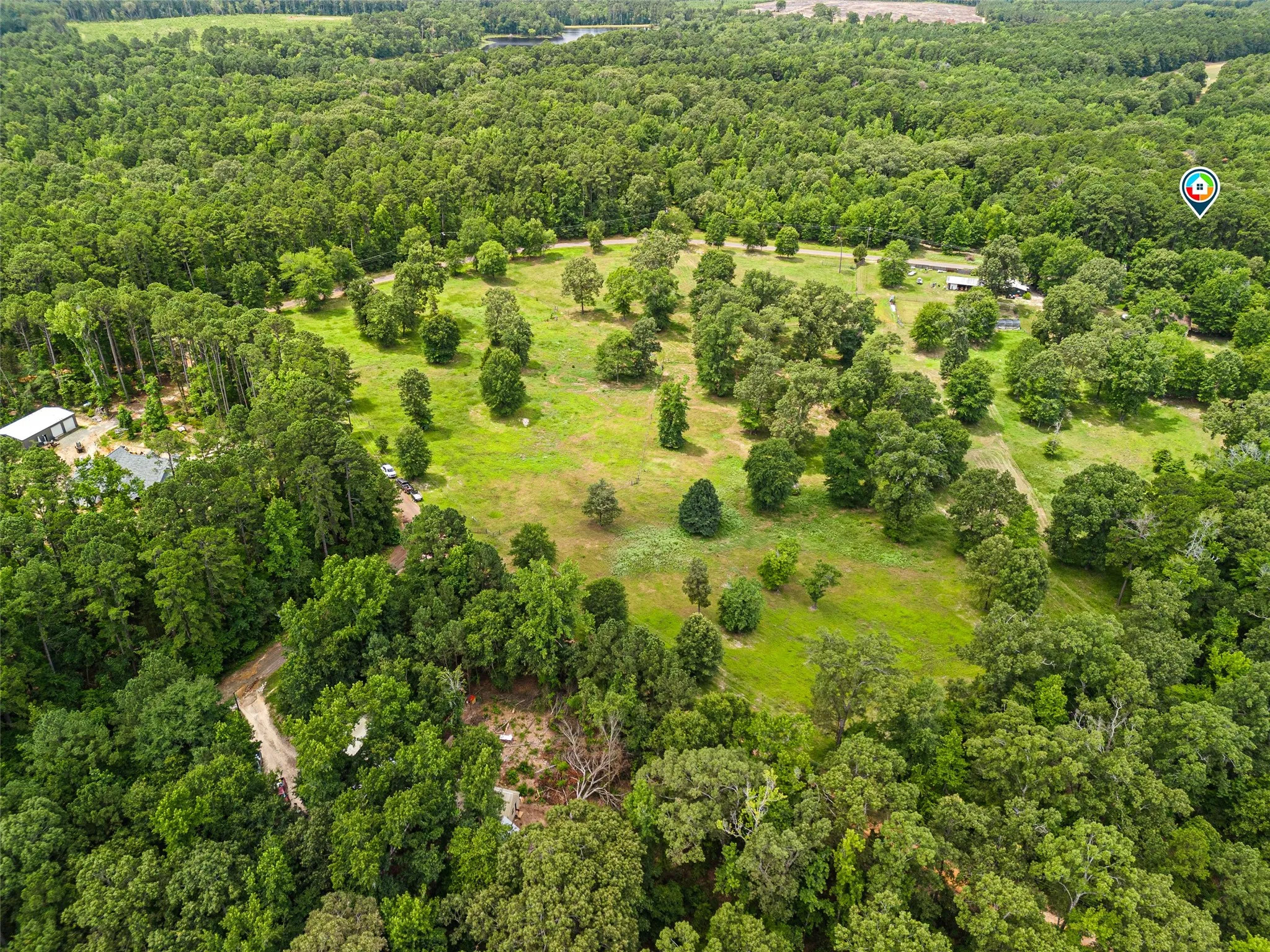 Expansive acreage featuring mature trees and open grassy areas