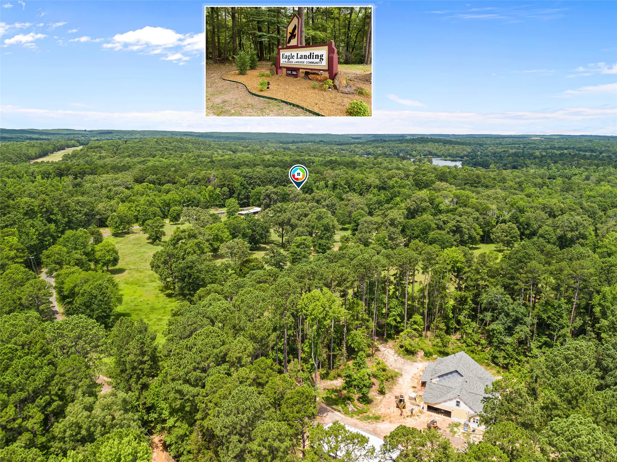 Expansive treed landscape with a single-family residence under construction