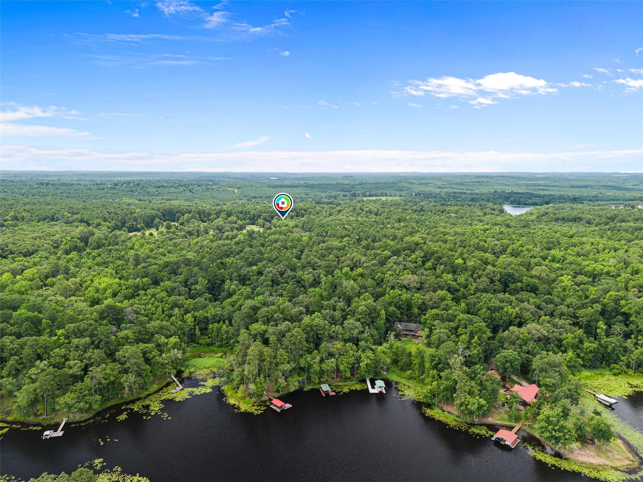 Expansive wooded landscape with waterfront access