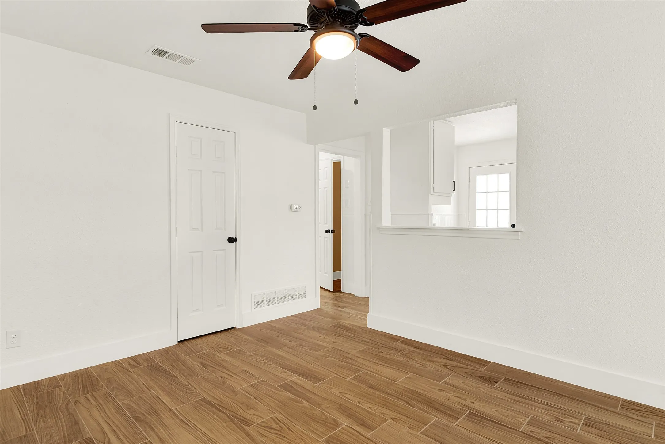 Spare room featuring wood finished floors and ceiling fan