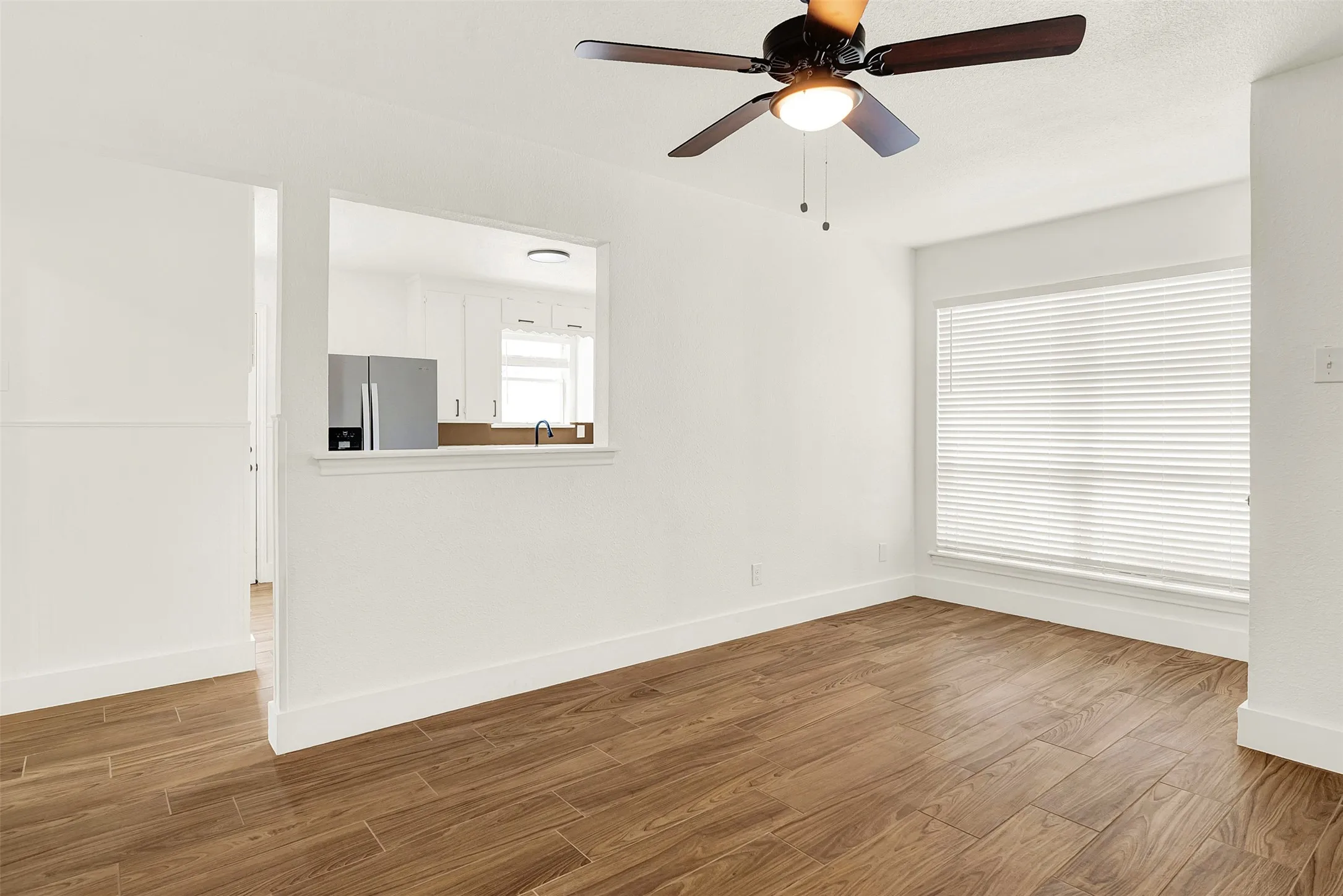 Unfurnished room with wood finished floors and a ceiling fan