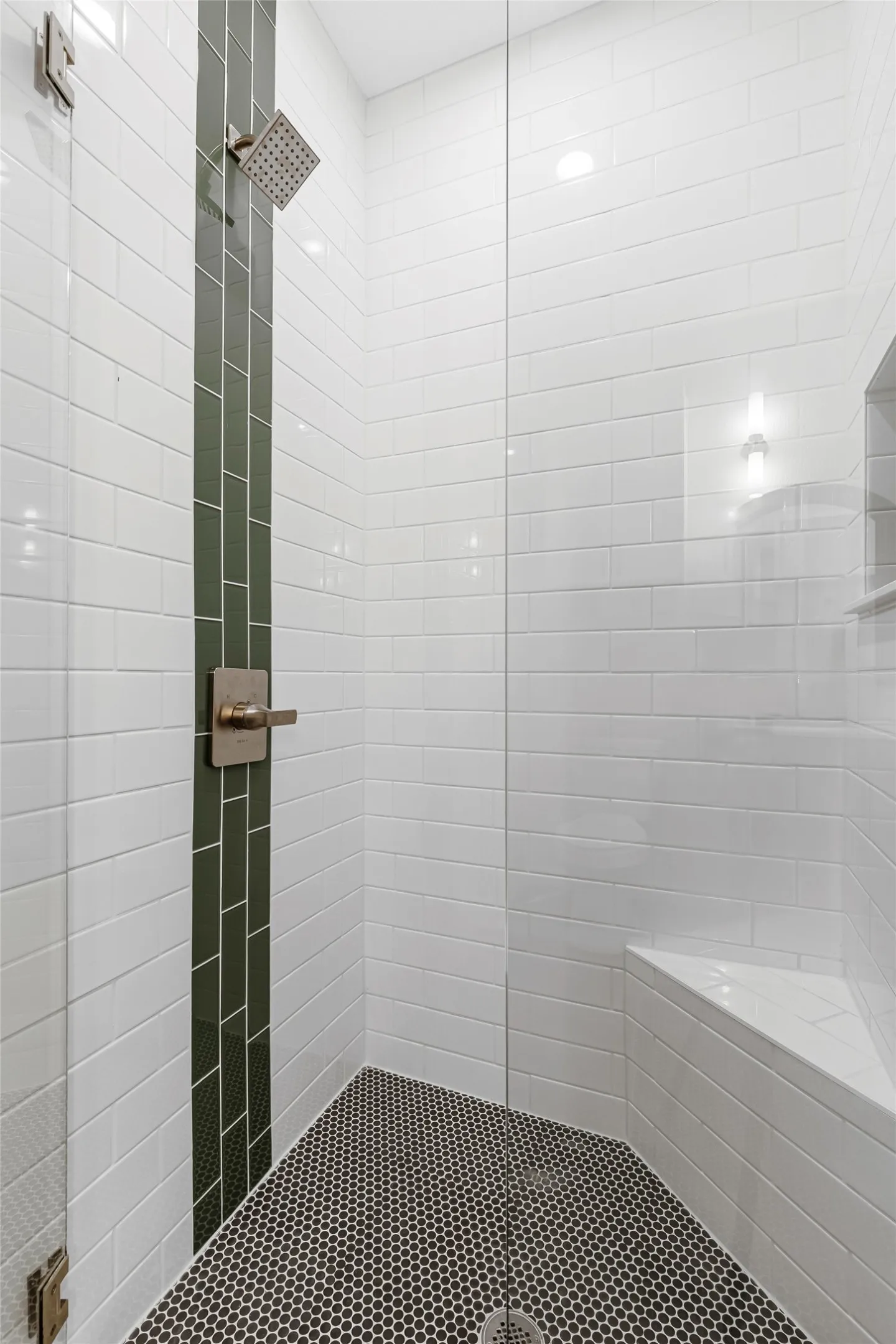 Bathroom with a tile shower and tile patterned flooring
