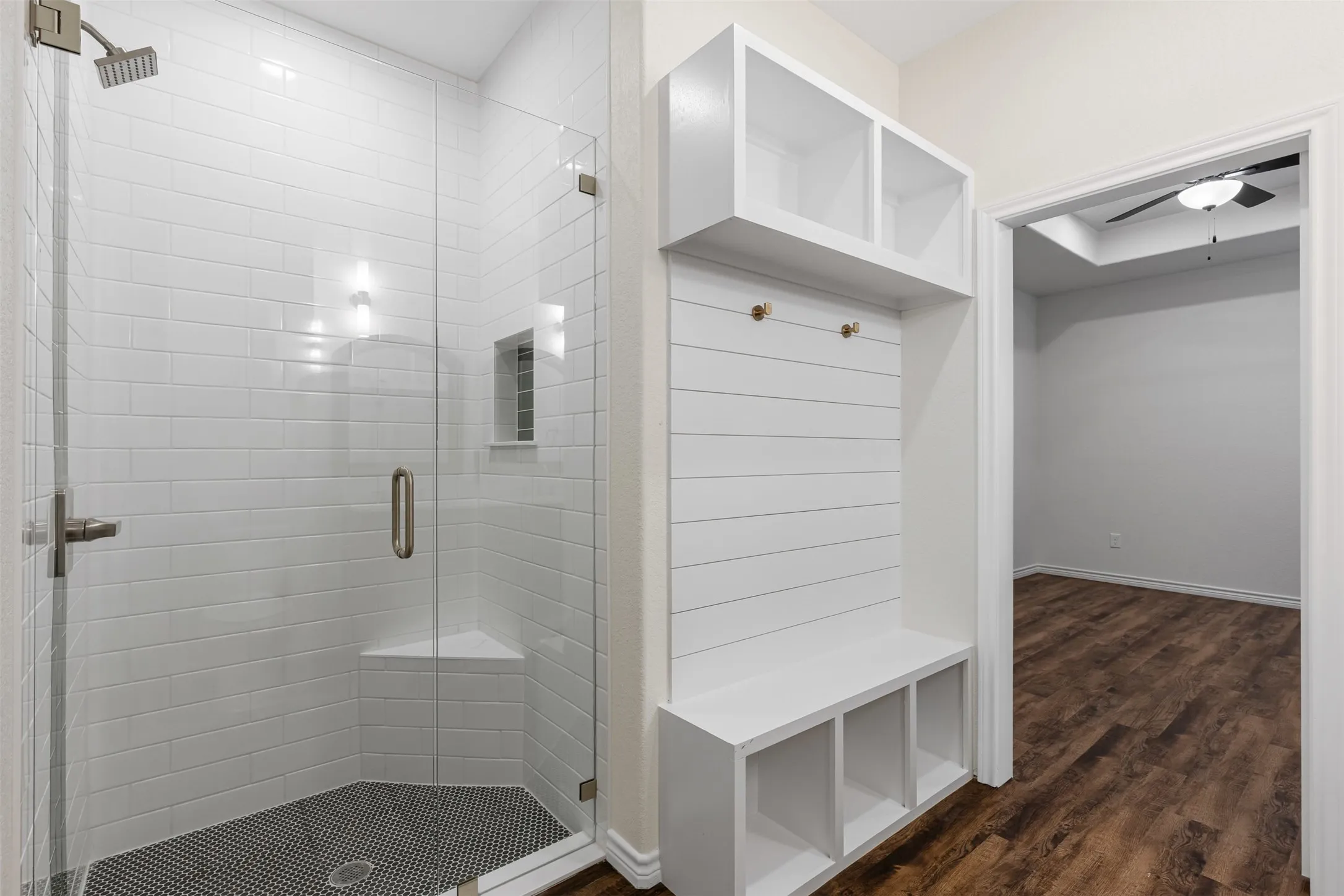 Mudroom featuring dark wood-style flooring and baseboards