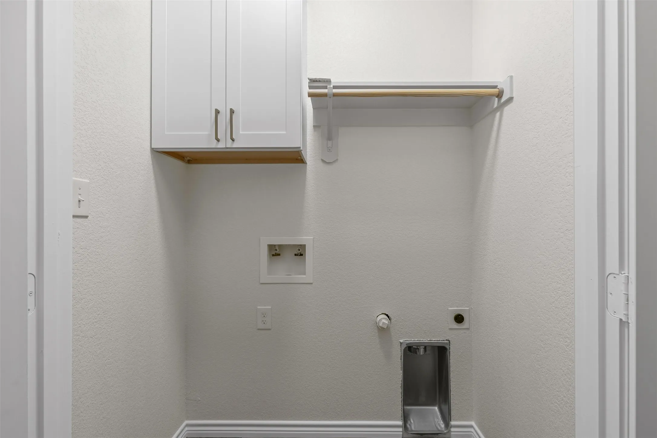 Laundry area featuring cabinet space, washer hookup, and electric dryer hookup
