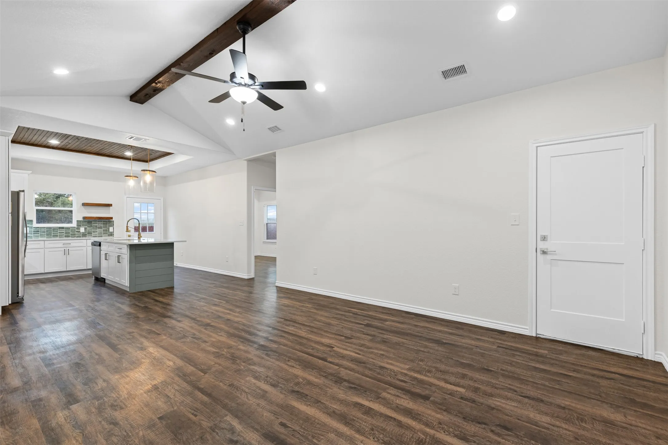 Unfurnished living room with a sink, recessed lighting, dark wood finished floors, a ceiling fan, and baseboards