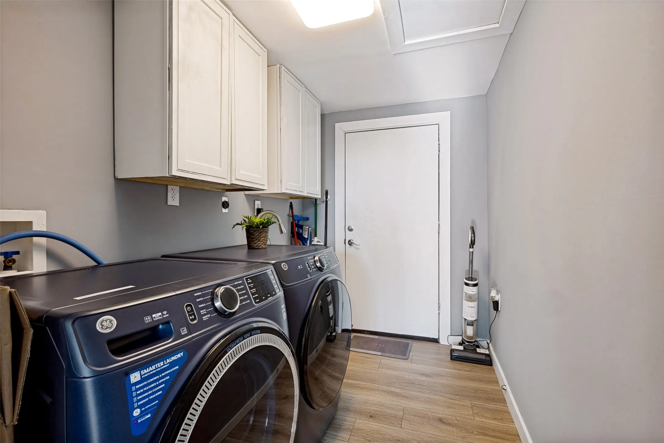 Laundry room is equipped with a sink and cabinets. Washer and dryer will convey with acceptable offer.