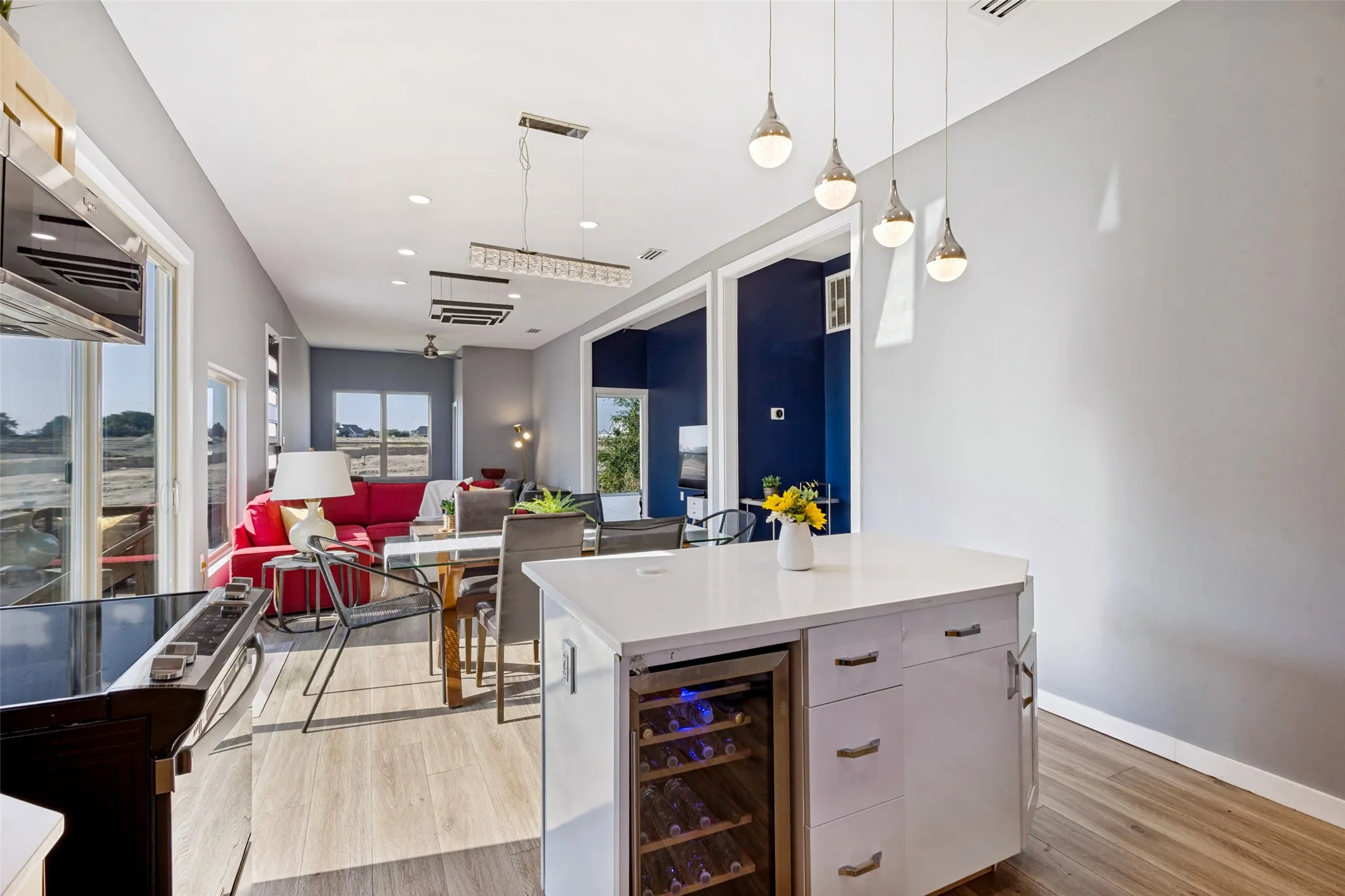 The house is equipped with tons of windows and natural lighting. Kitchen has an island and wine refrigerator.
