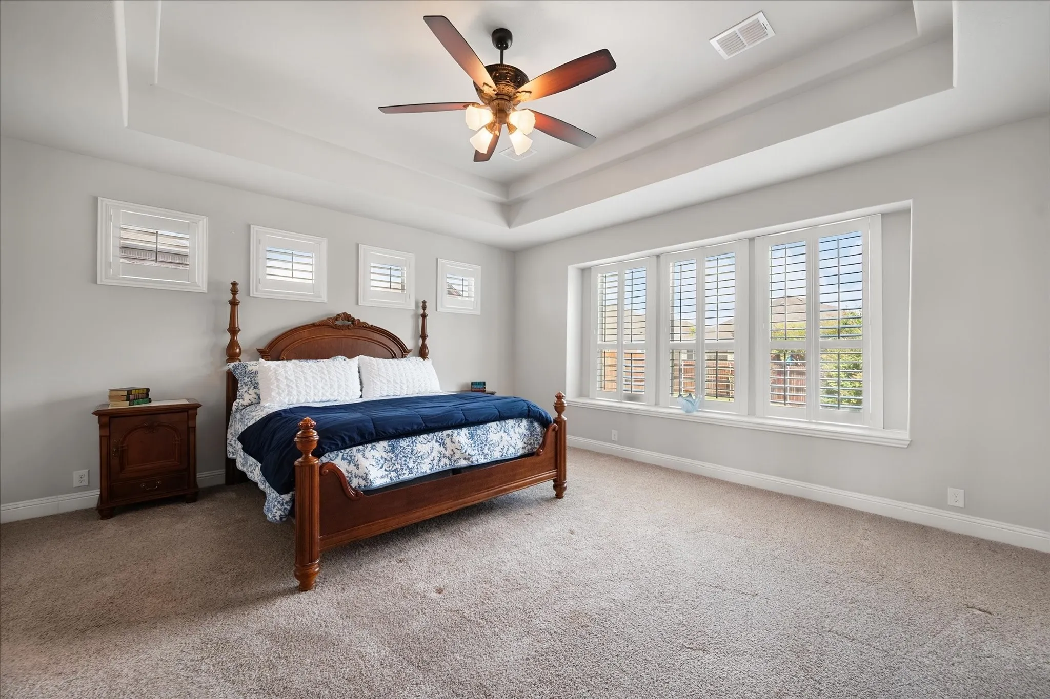 Primary bedroom with large wall of windows