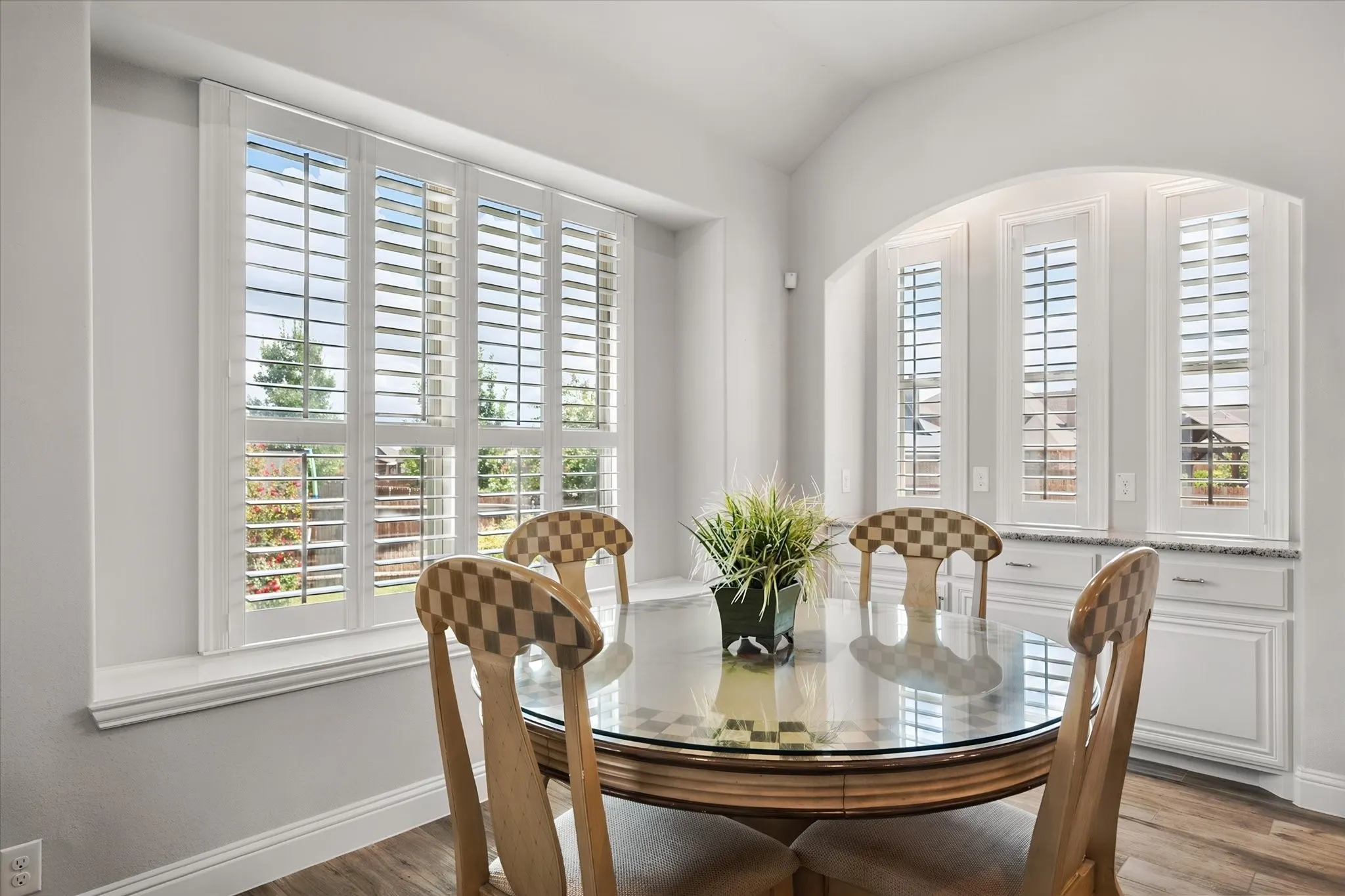 Breakfast area with bay windows and cabinets and granite counter top for a bar or coffee bar area