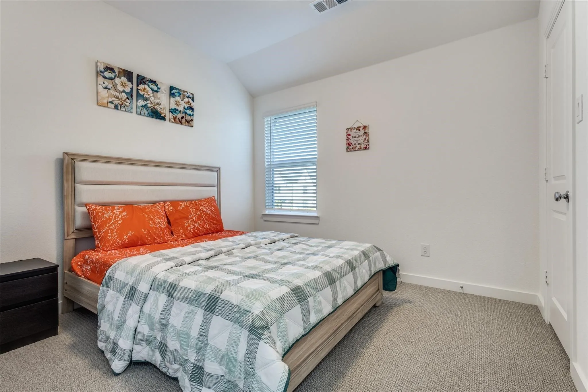 White walls, vaulted ceiling, and a window with blinds