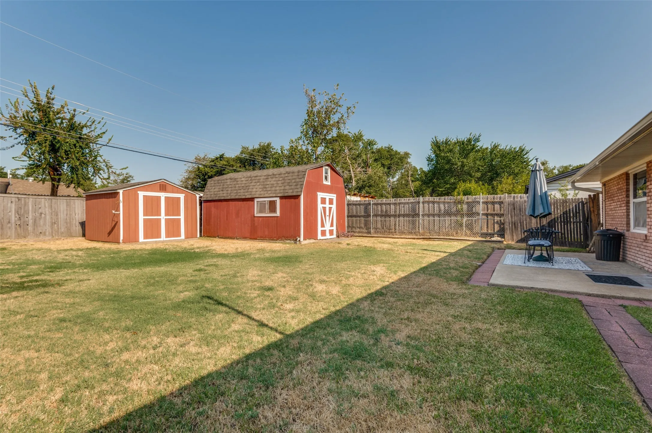 Backyard with 2 storage buildings
