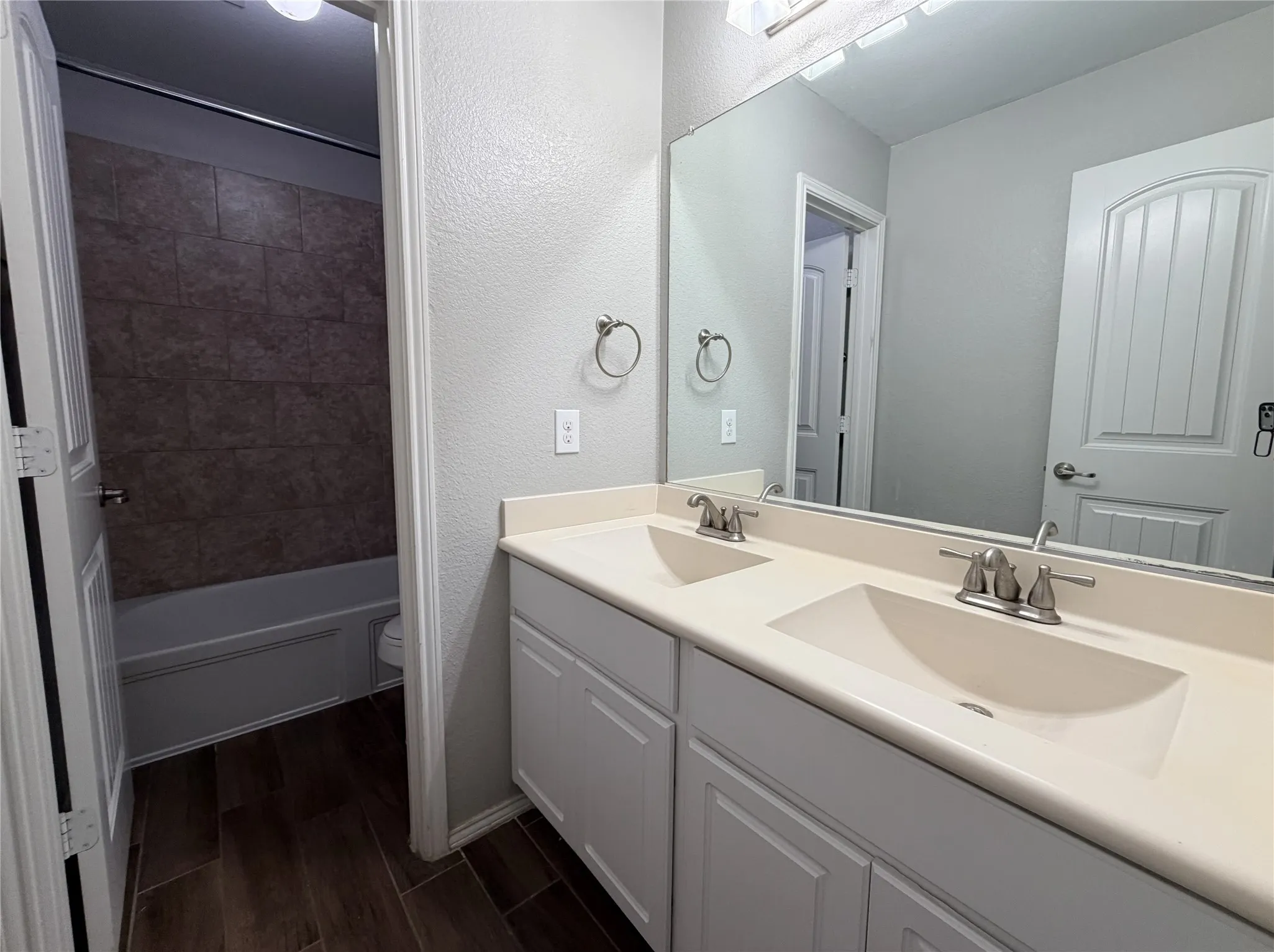 Dual vanity with integrated sinks and brushed nickel fixtures
