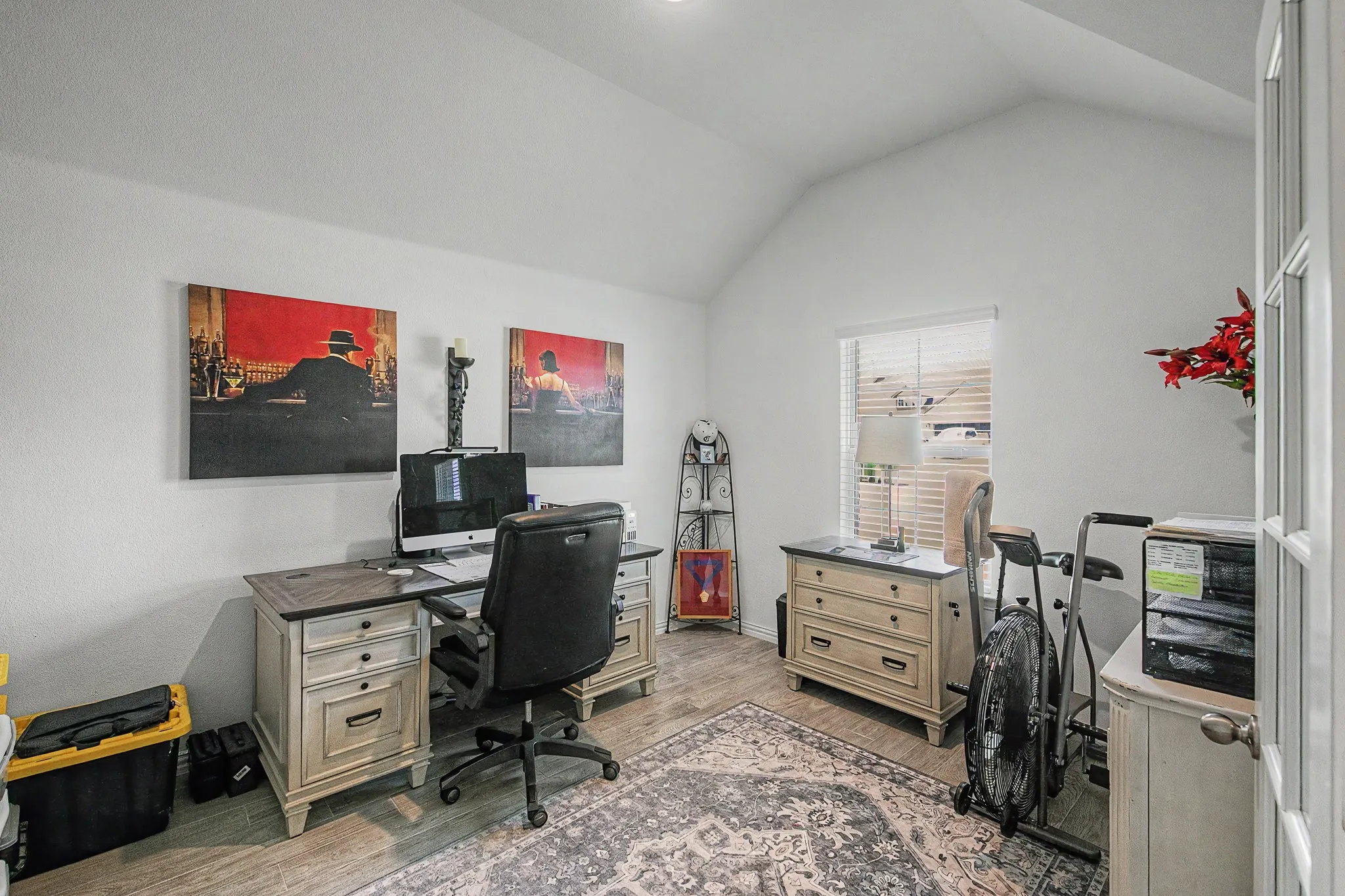 Vaulted ceiling, wood-finish flooring, white walls, and French doors