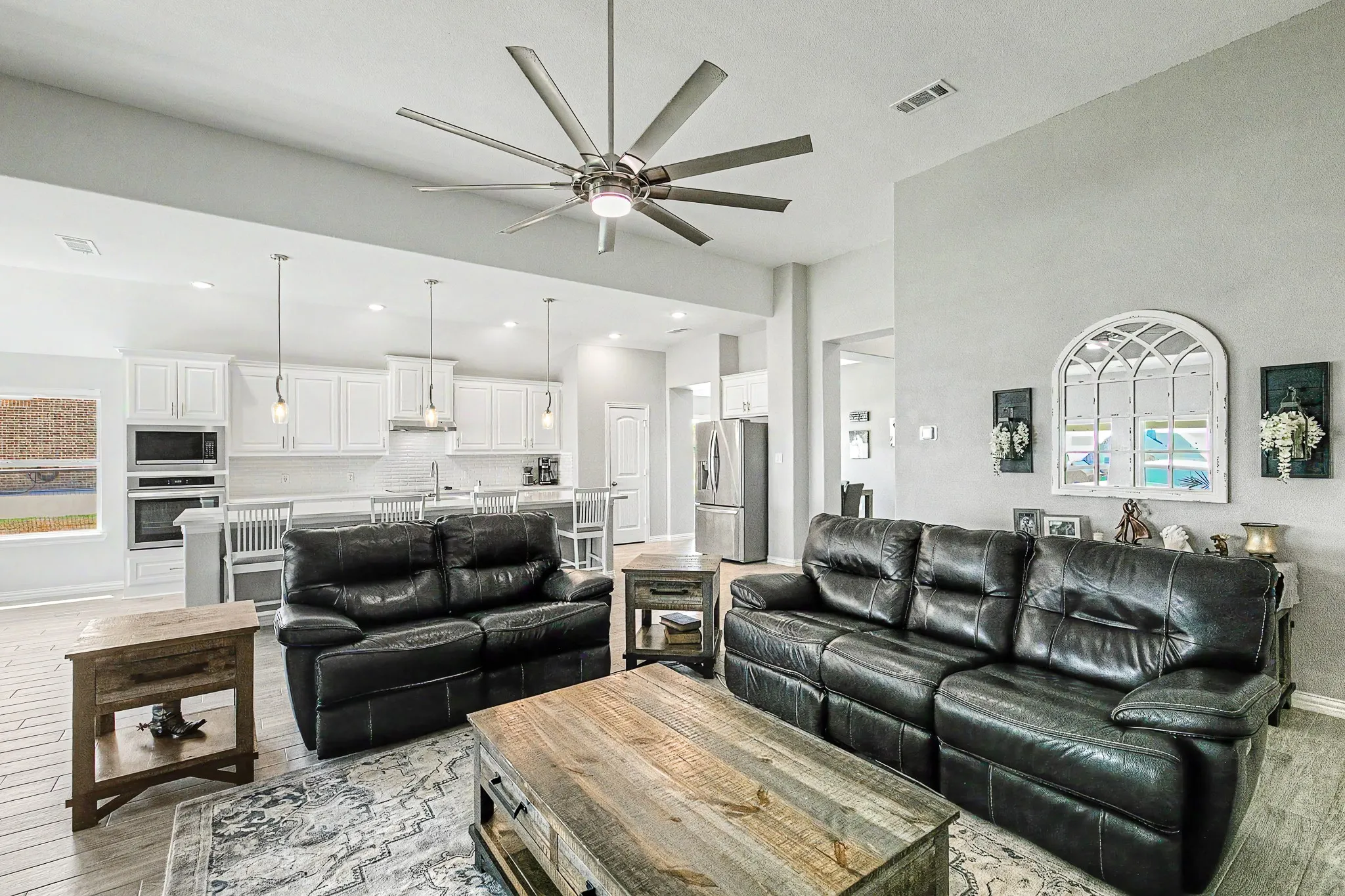 Open-concept living space with a contemporary ceiling fan, recessed lighting, and wood-finish flooring