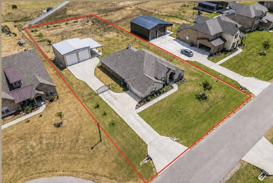 Single-story residence with a stone and siding exterior, concrete driveway, and attached garage
