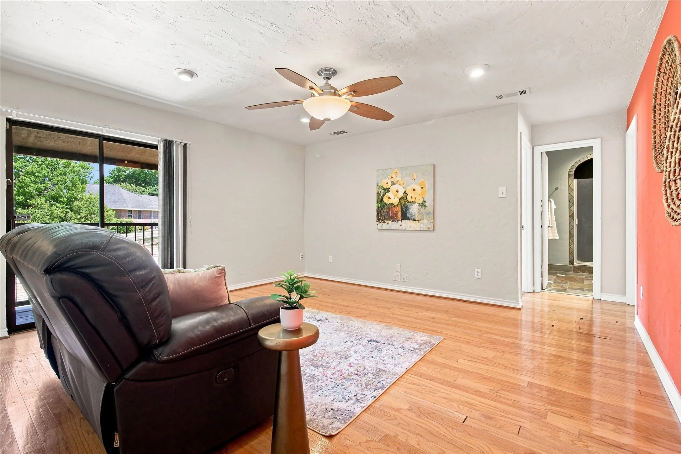 Upstairs family room with wood flooring and balcony