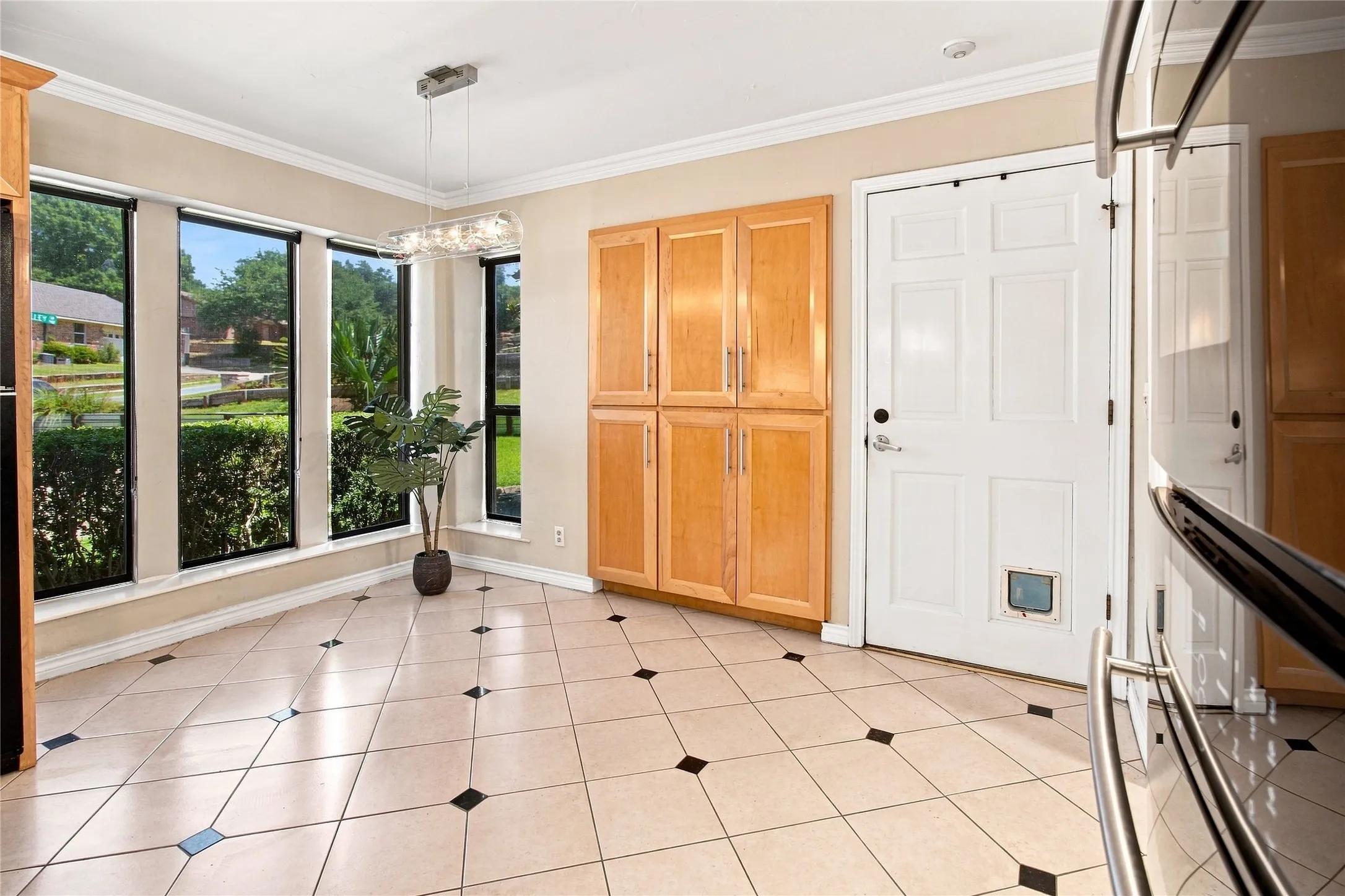 Dining area just off kitchen with large windows for natural light