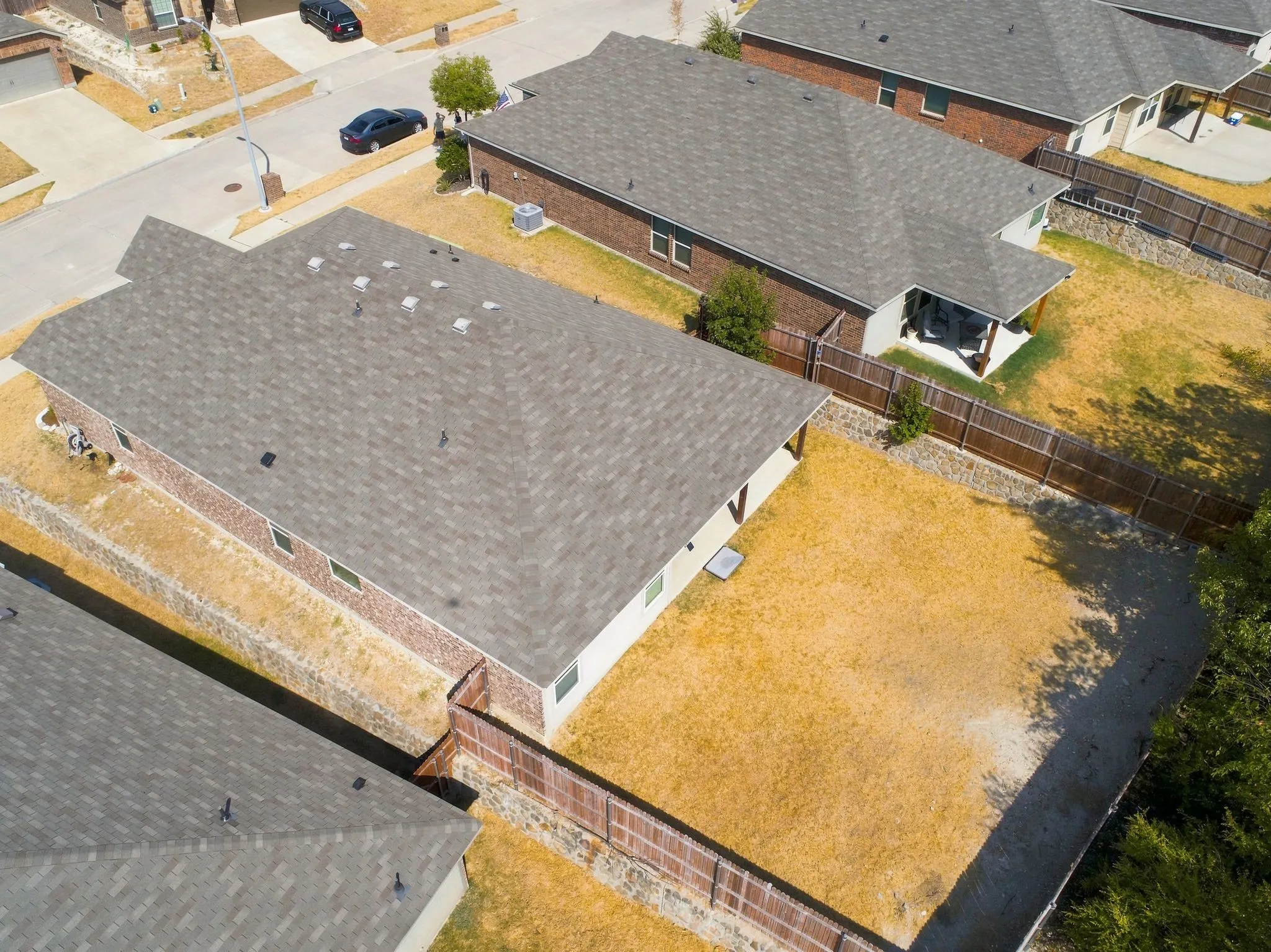 Residential property featuring a shingle roof and large backyard