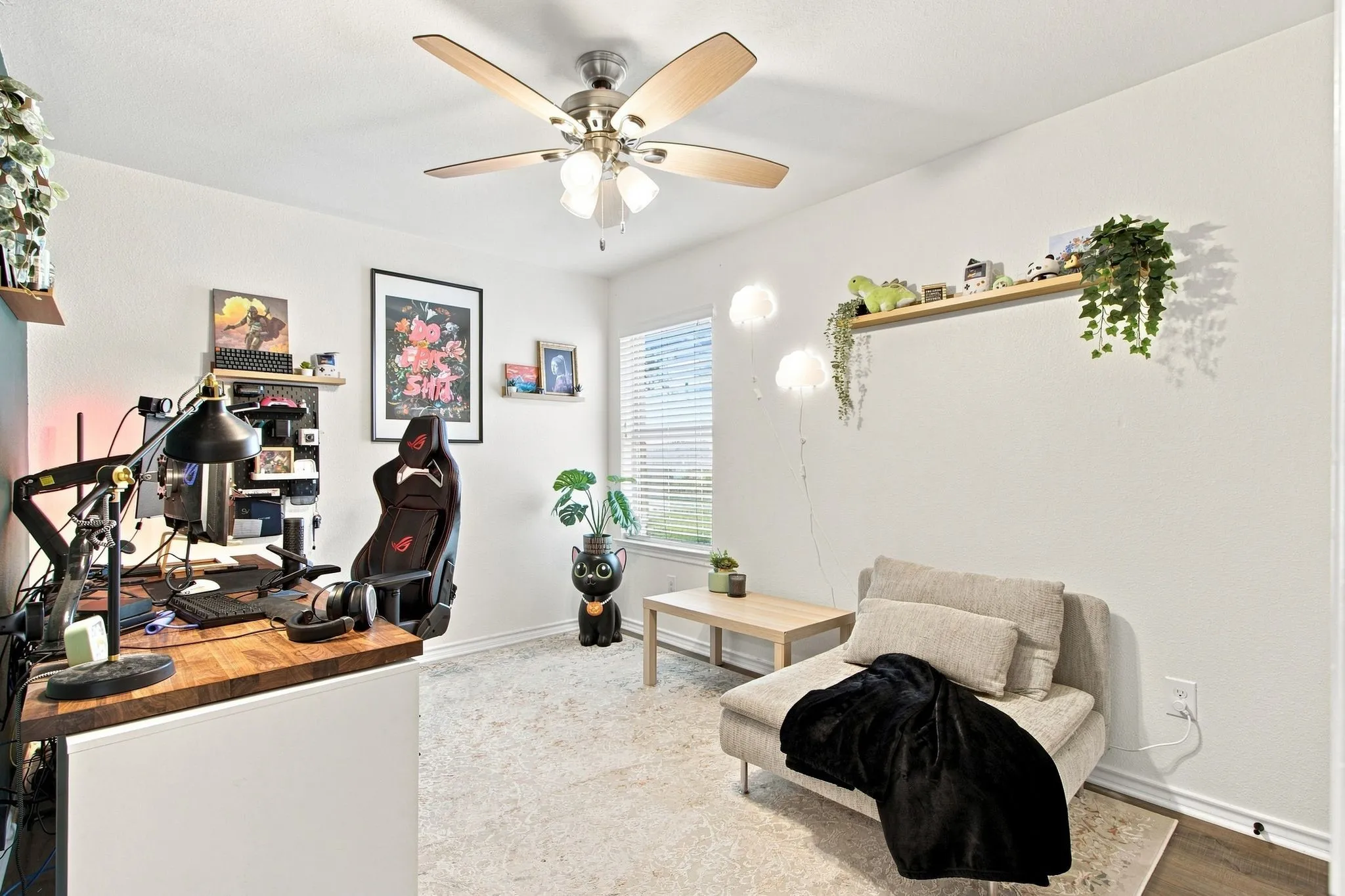 Ceiling fan with light fixture, window with blinds, LVP Flooring, built-in wall shelving, and wall-mounted floating shelves. Bedroom 3