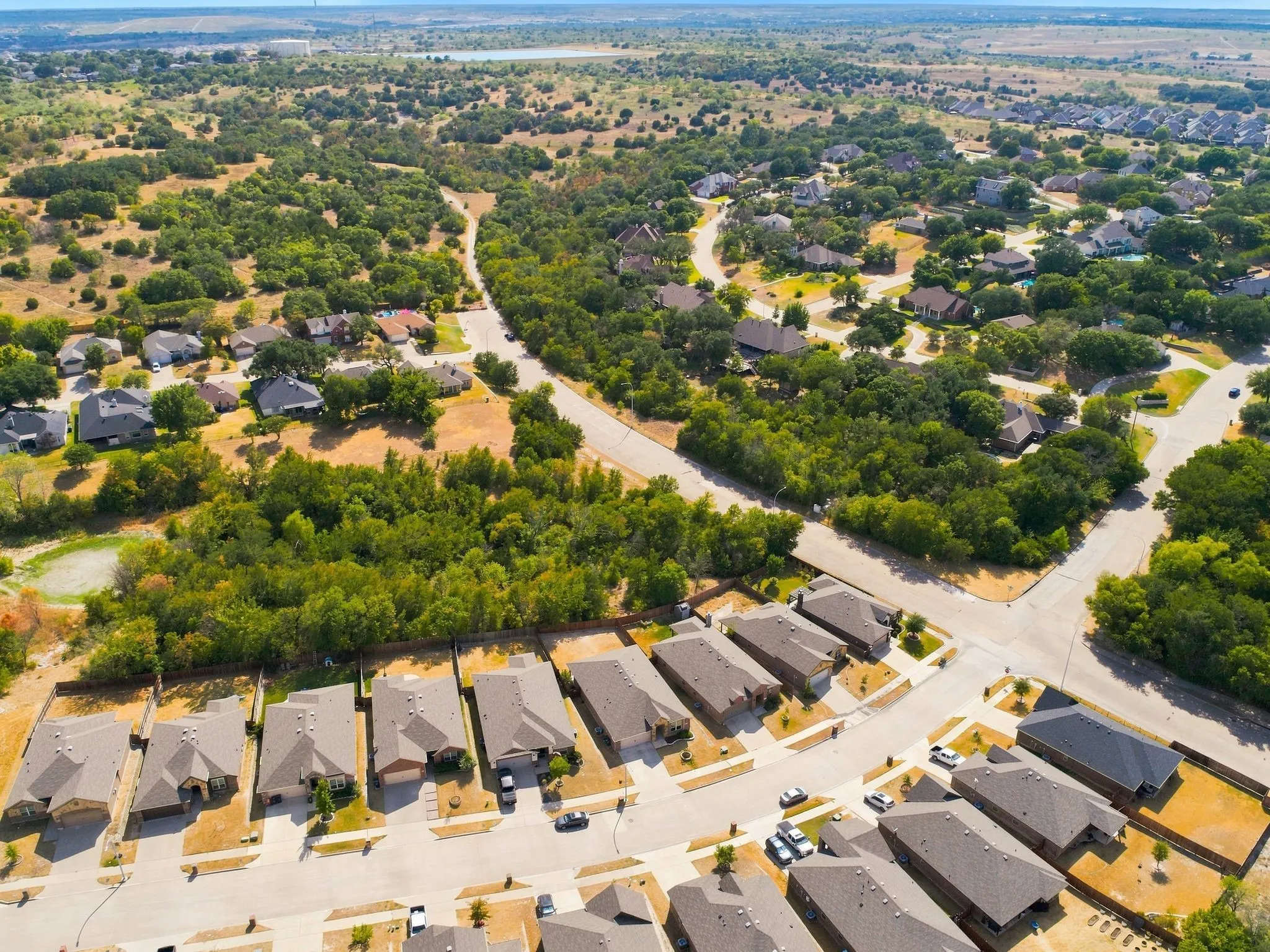 Residential development featuring a varied street pattern, established homes, and natural landscaping