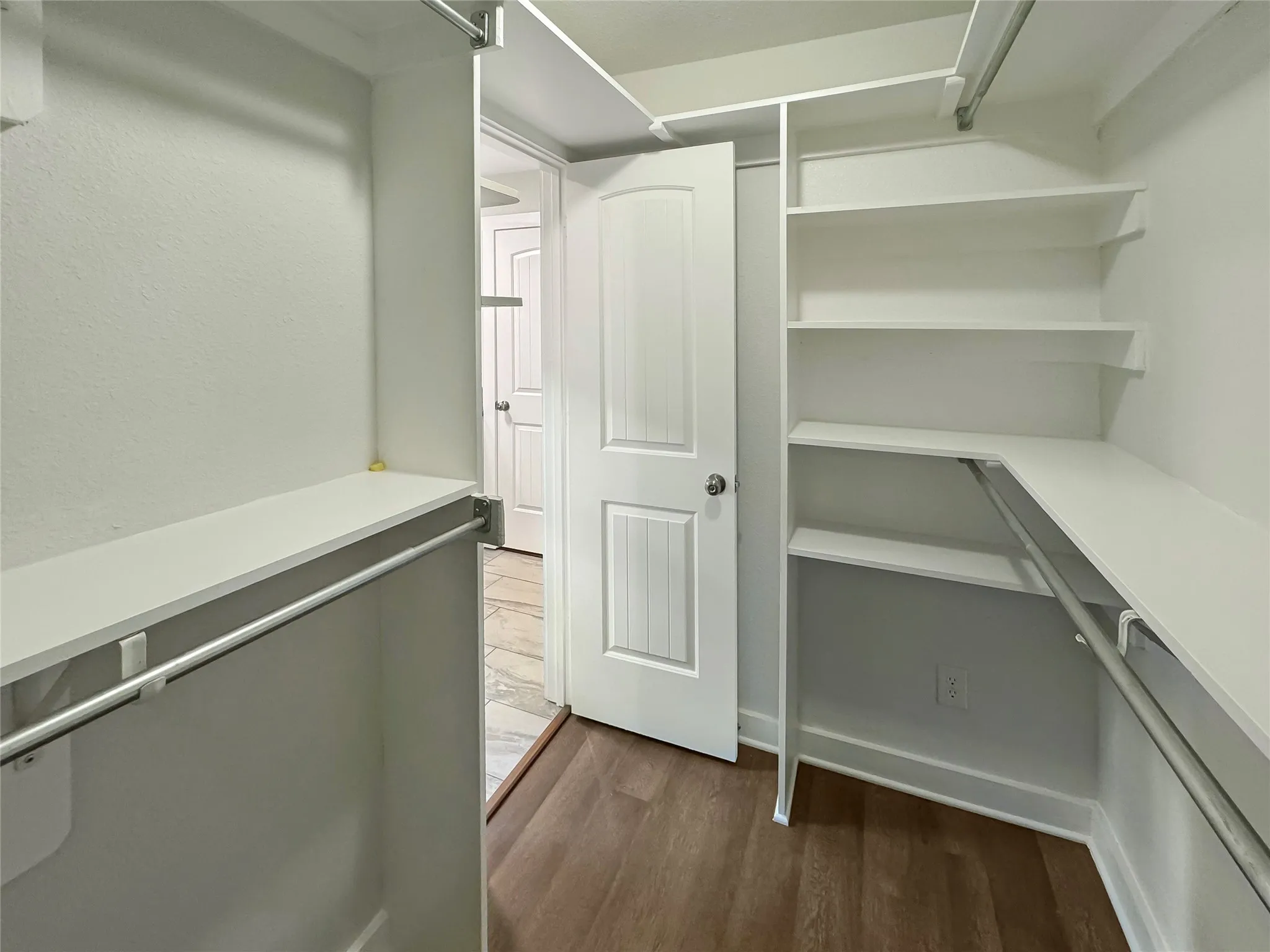 Walk-In Closet located the Primary Bathroom featuring Built-in closet shelving and hanging rods