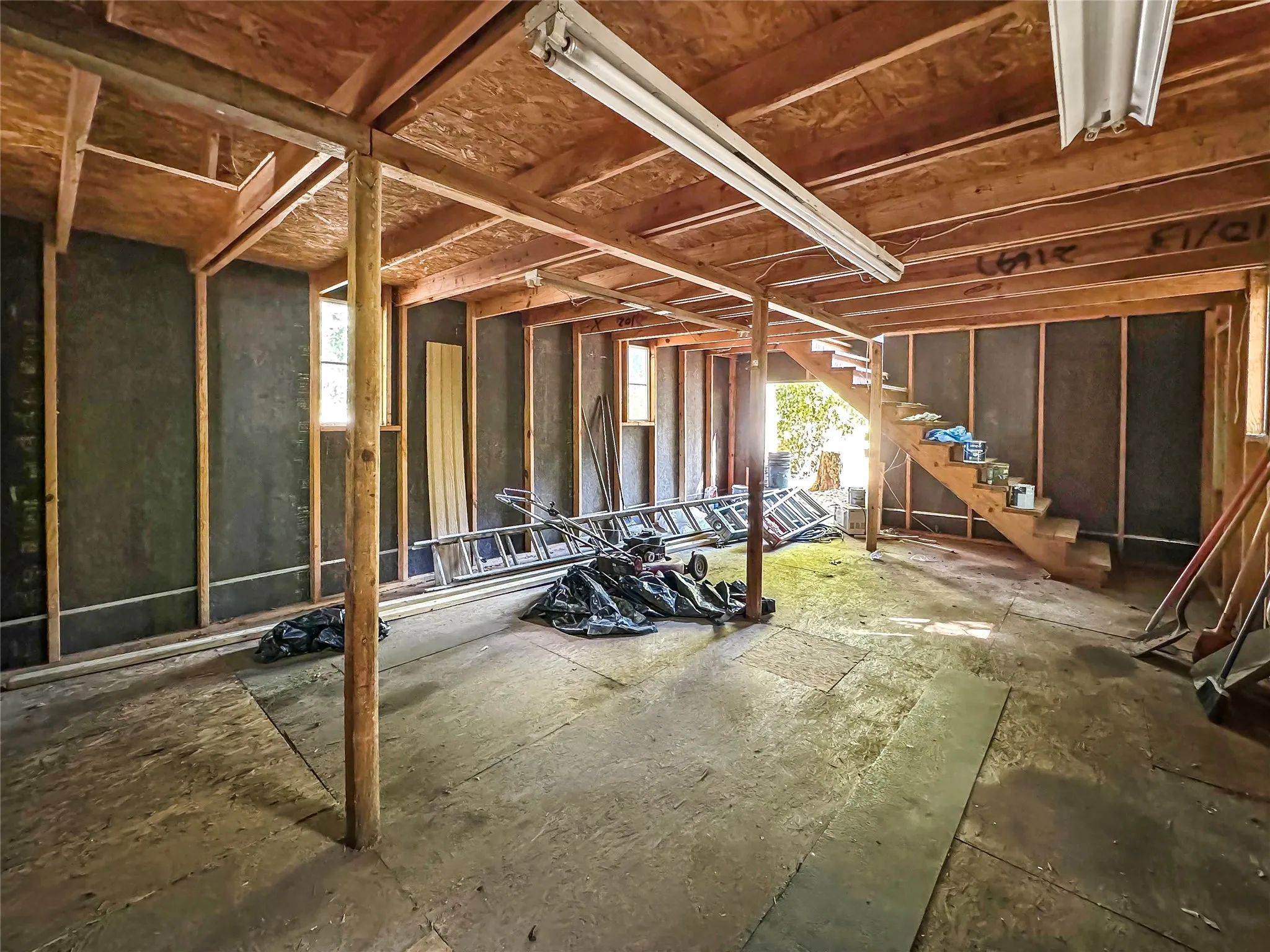 Two-Story Barn/Workshop - Exposed wood framing, unfinished walls, and wood subflooring