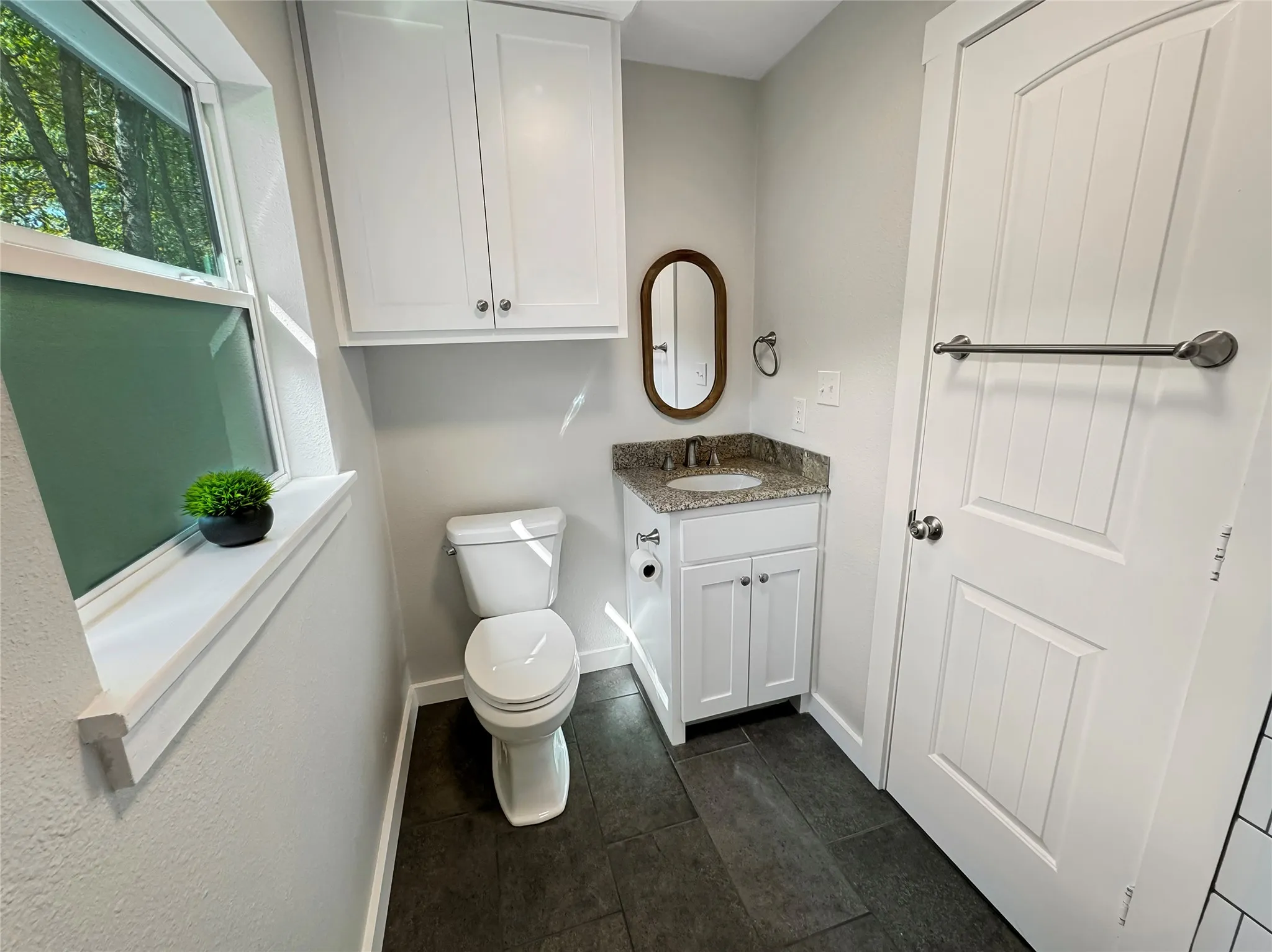 Hallway Bathroom - White shaker vanity with granite countertop, undermount sink, and brushed nickel faucet