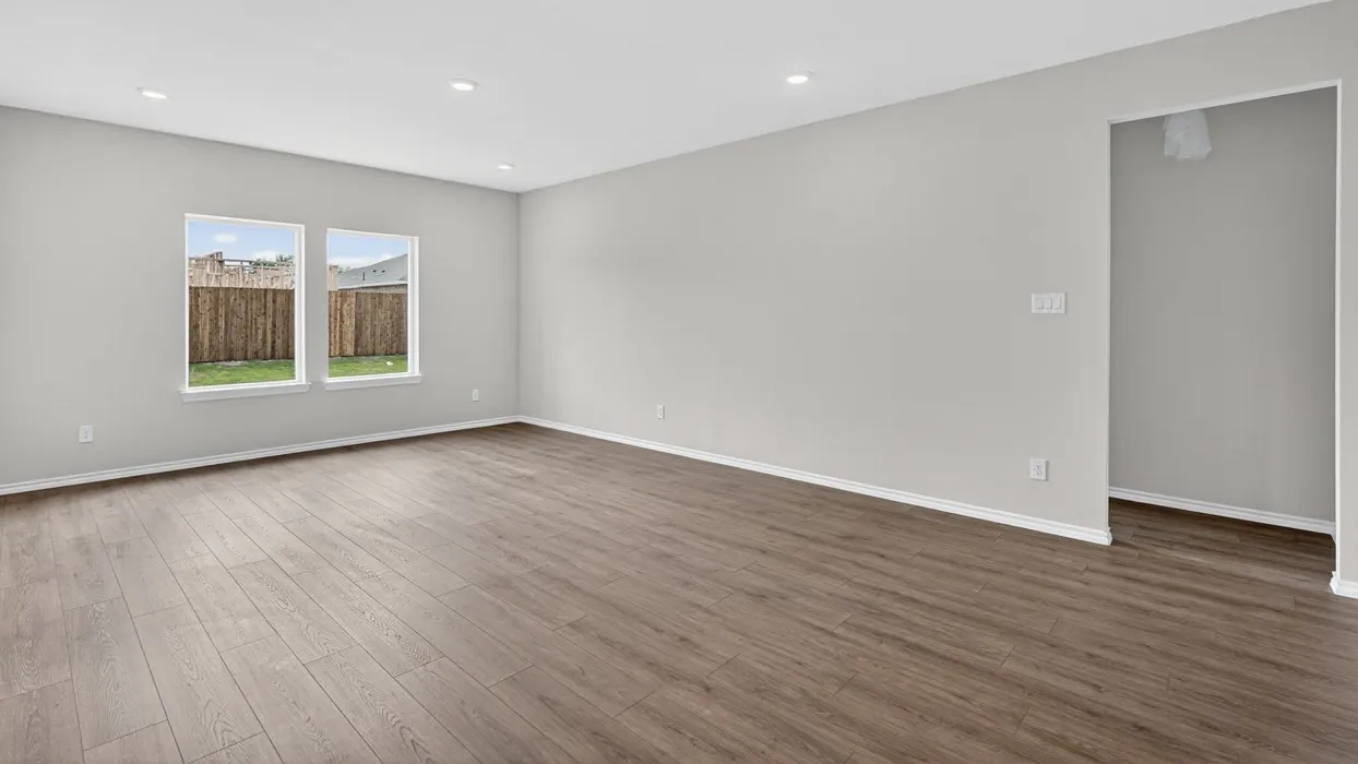 Spacious interior featuring wood-finish flooring, recessed lighting, and light gray walls