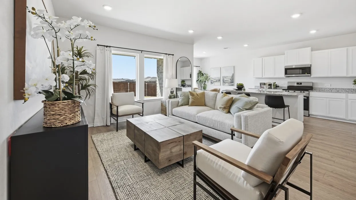 Open-concept living area featuring wood-finish flooring, recessed lighting, and large windows