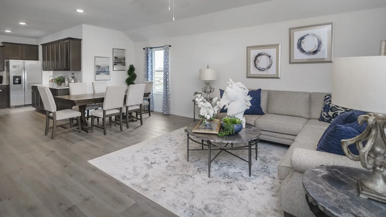 Open-concept living area featuring wood-finish flooring, recessed lighting, and vaulted ceilings