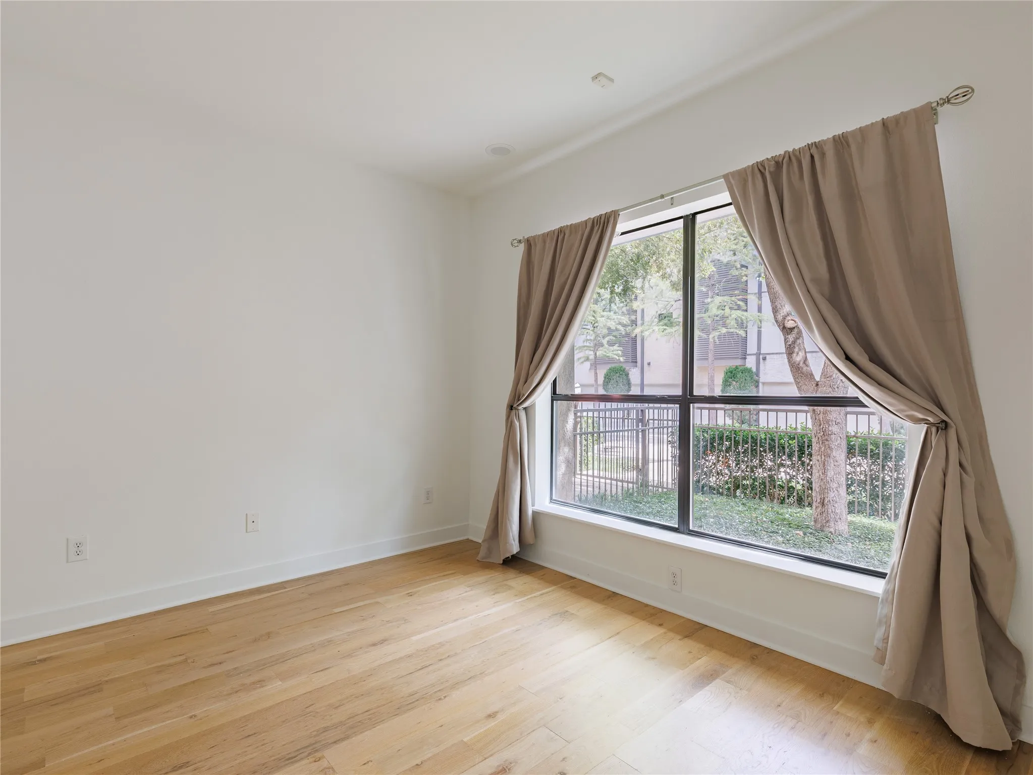 Versatile first-floor bedroom with ample space for guests, a home office, or everyday living.