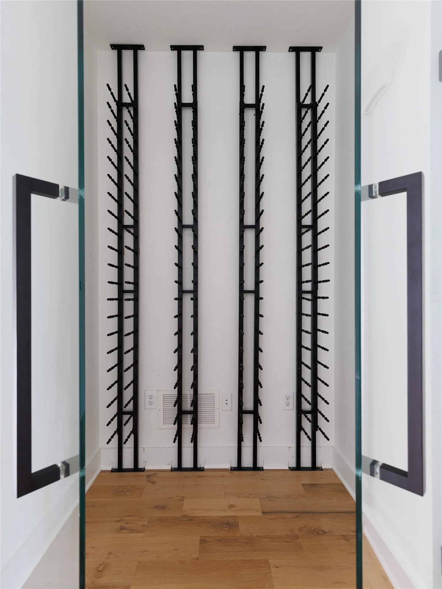 Dedicated wine room offers a refined space to display and organize a personal collection.