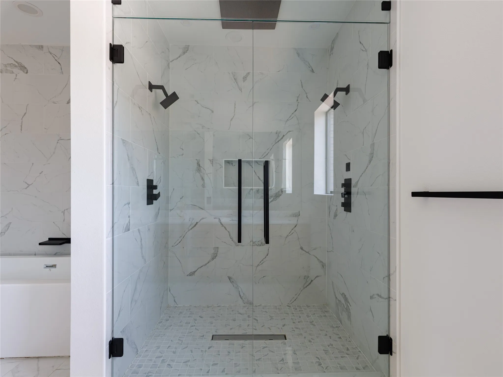 Spa-like primary bath with a standalone soaking tub and an expansive walk-in shower designed for everyday comfort.