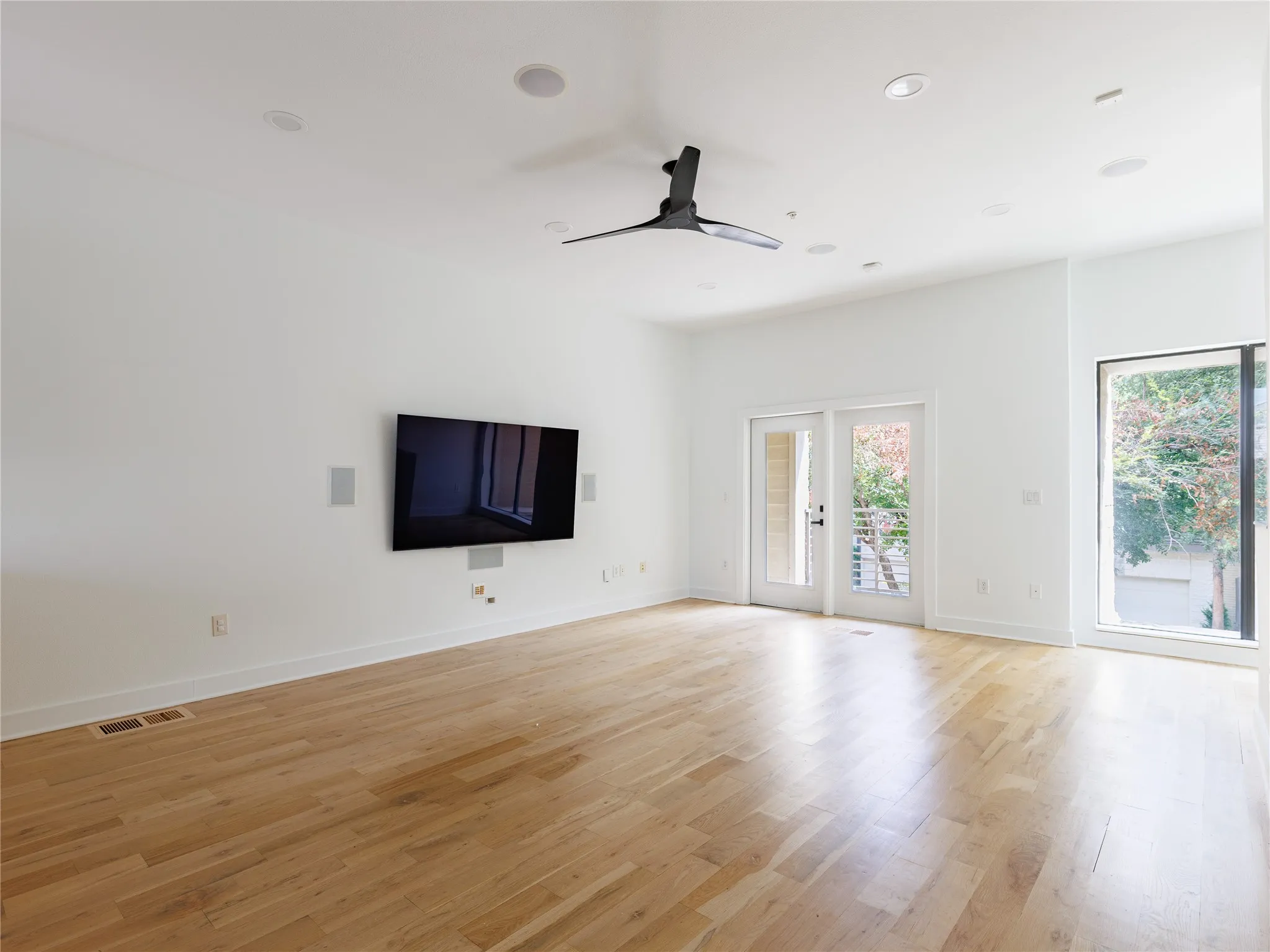 Natural light fills the spacious living area through glass doors and a large picture window.