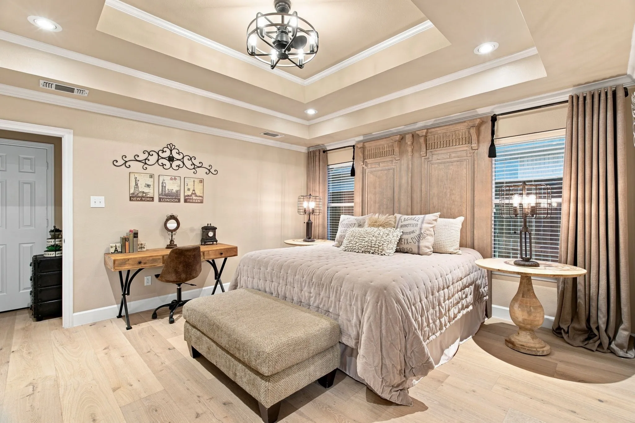 Recessed lighting, light wood-finish flooring, tray ceiling, decorative ceiling fan, and window treatments