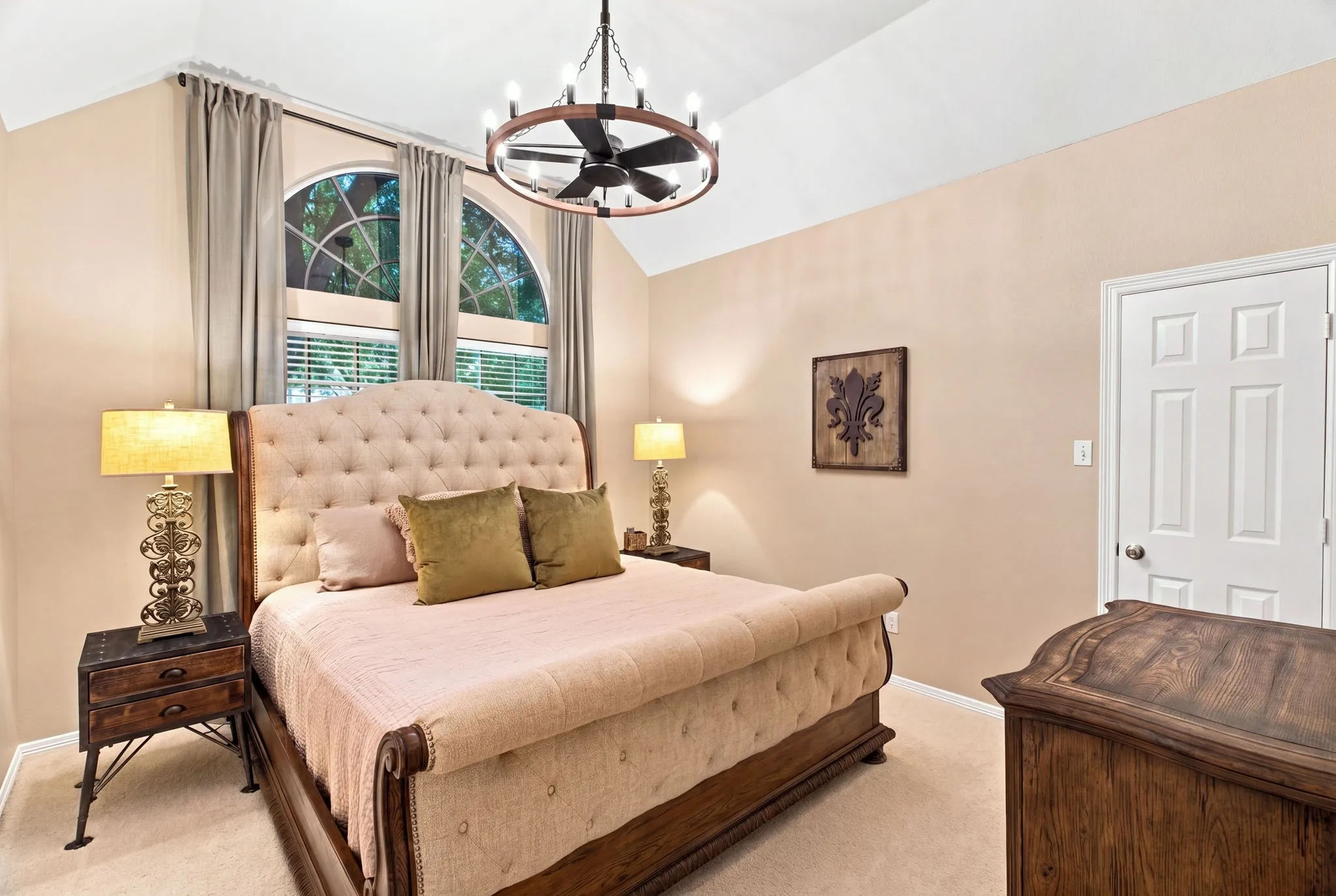 Vaulted ceiling featuring a decorative chandelier with integrated fan