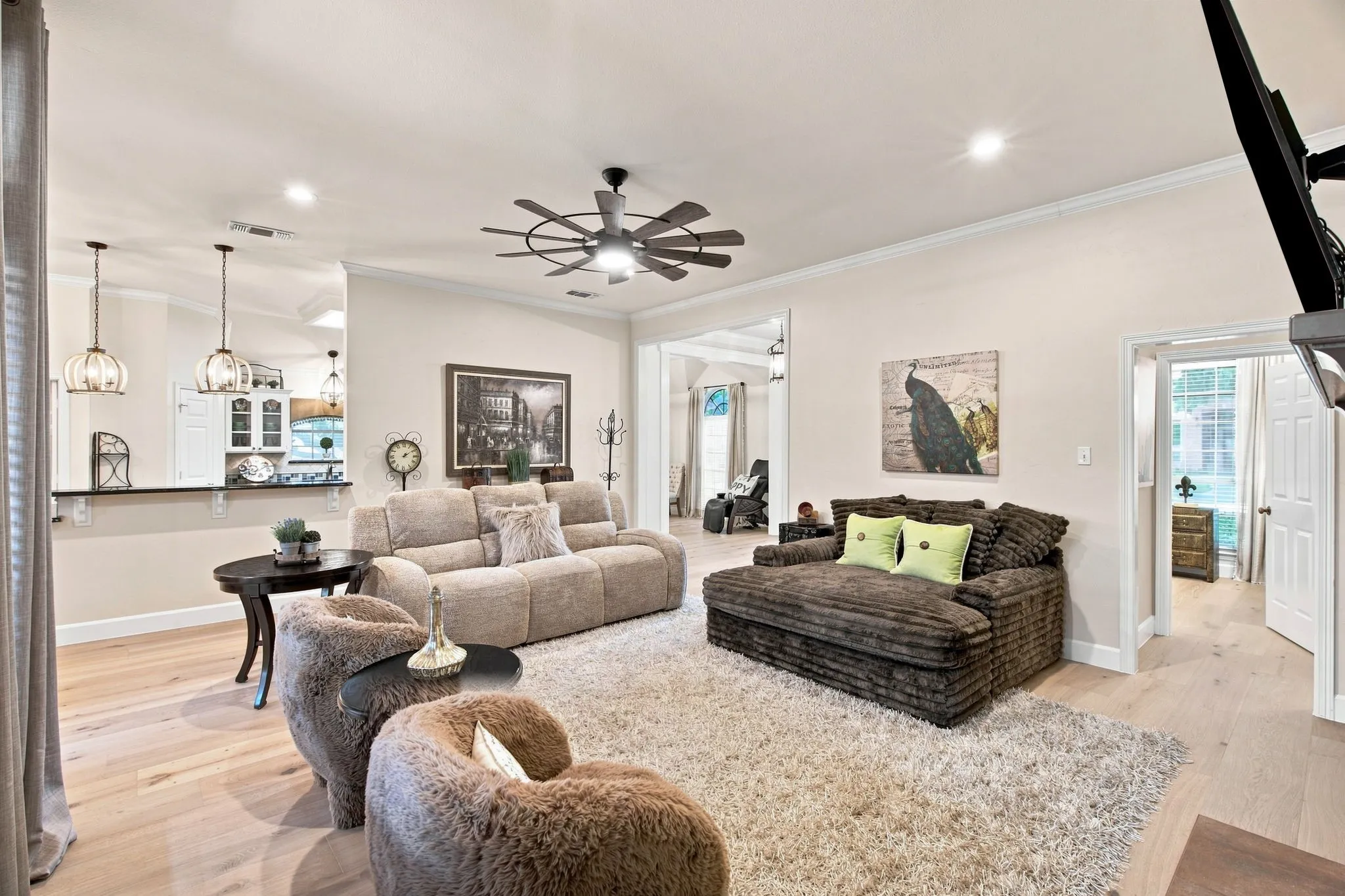 Open-concept living area featuring wood-finish flooring, recessed lighting, and a ceiling fan