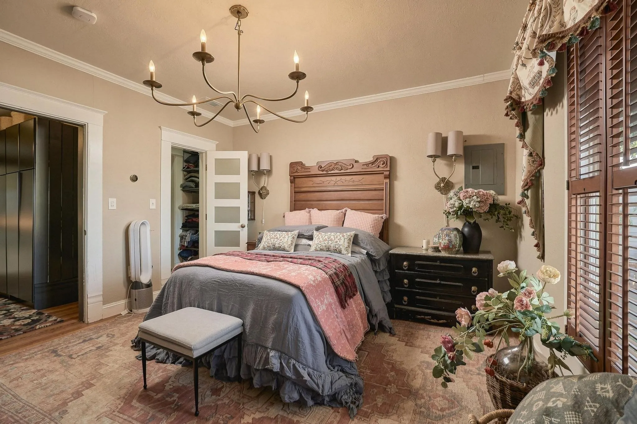 This serene retreat with timeless wooden shutters, designer lighting and direct access to a private walk-in closet is the perfect place to relax and unwind.