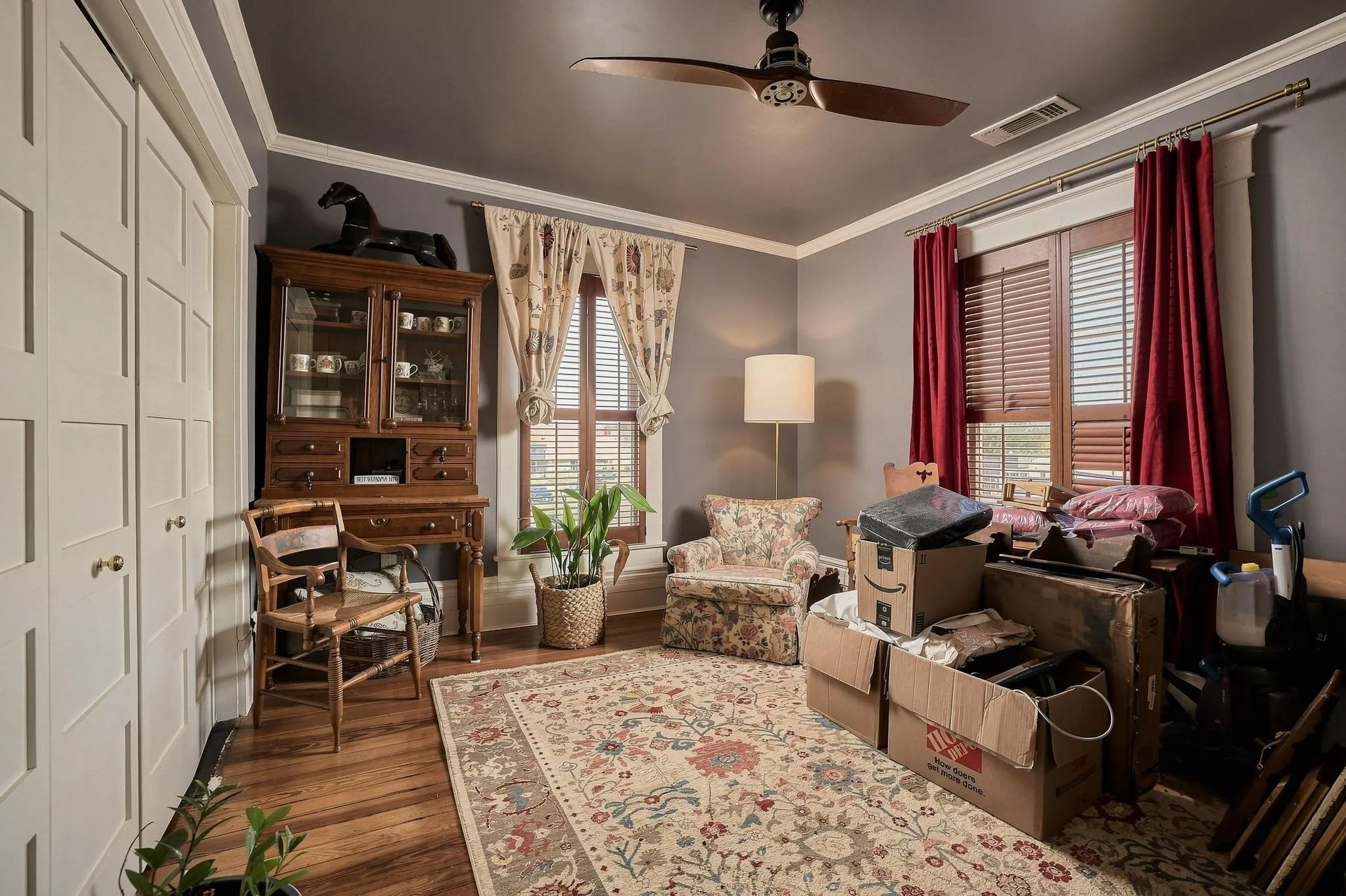 A stunning painted ceiling, modern fan and warm hardwood floors in this versatile room perfect for a bedroom, library or private office.