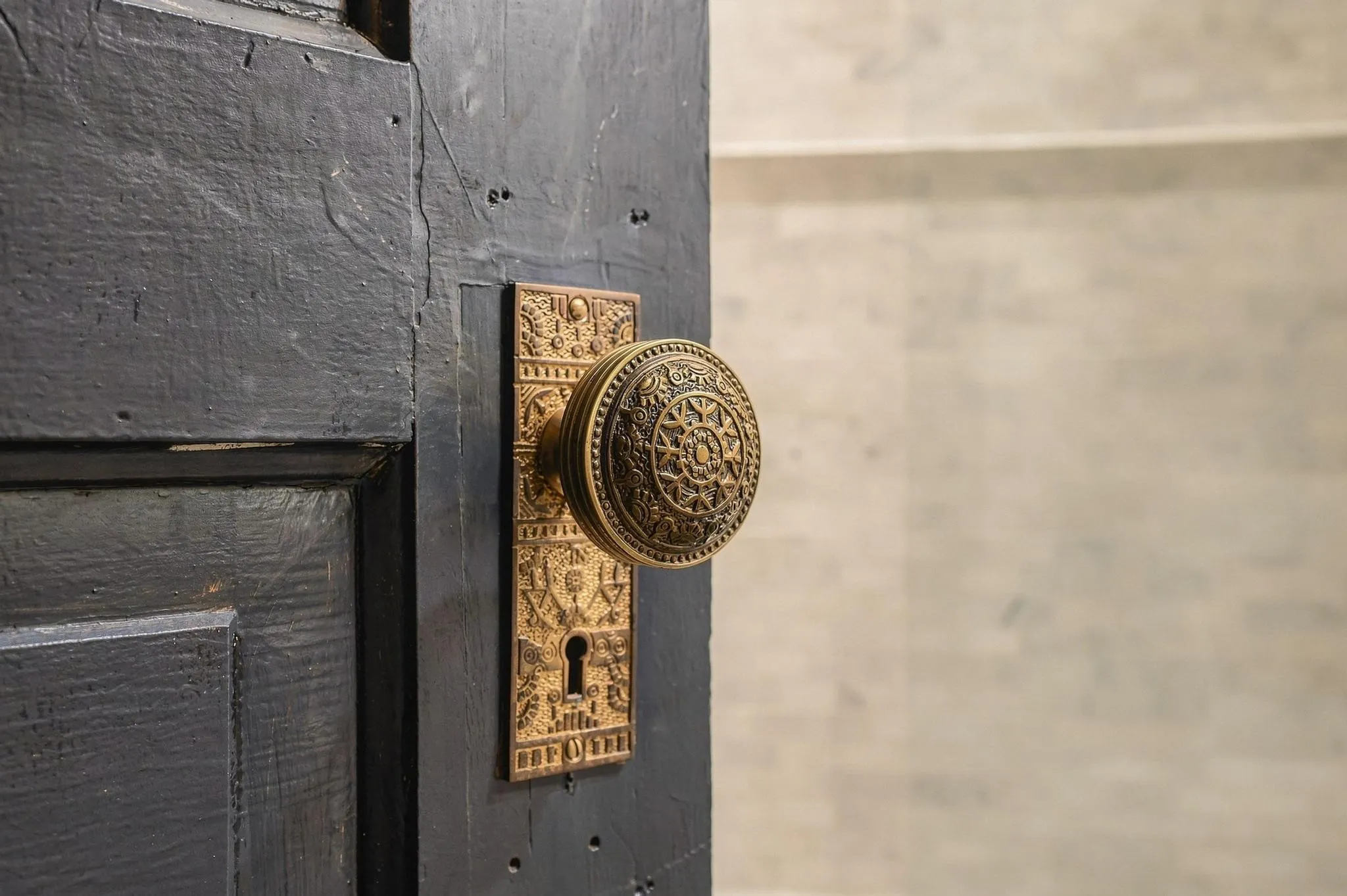 The ornate antique brass doorknob is an example of thoughtful historic preservation.
